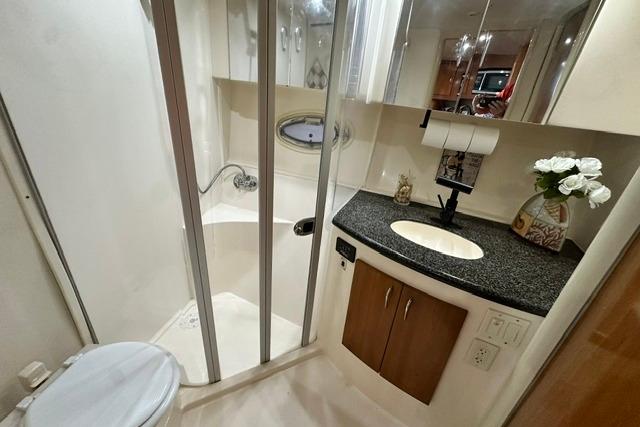 Bathroom interior of 2004 Carver 360 Mariner yacht with shower, sink, and toilet.