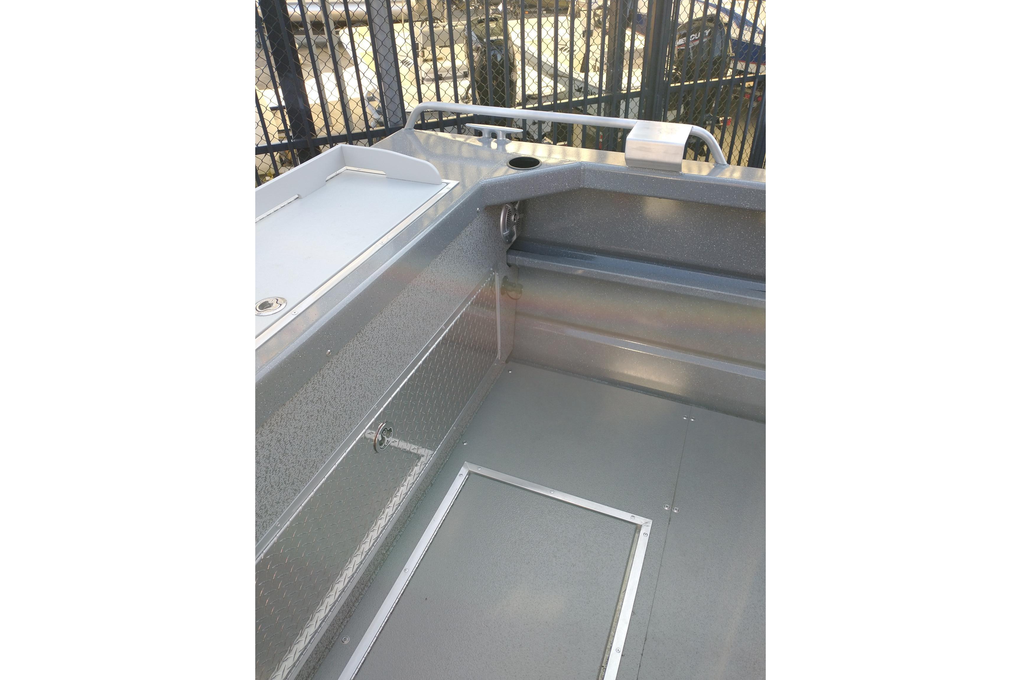 Interior view of 2024 Spartan 220 Maximus Pro boat, featuring sleek metal finish and storage compartments.