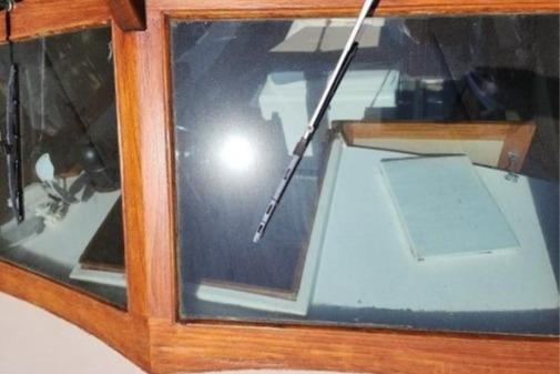 1985 Wasque Down East Cruiser interior with wooden trim and windshield wiper.