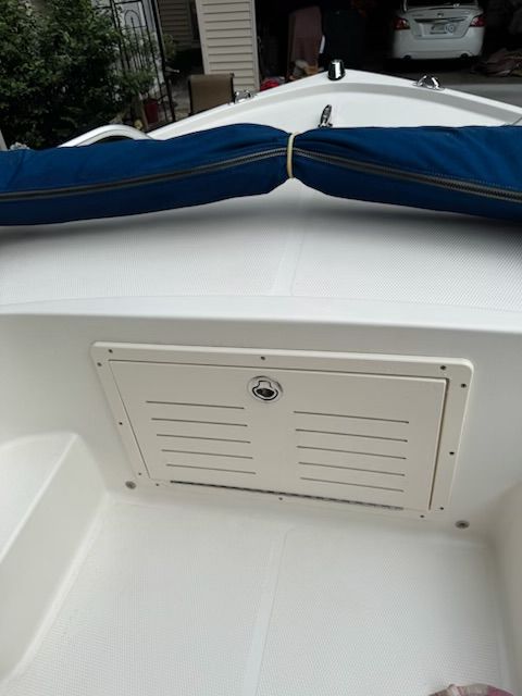 2006 Mako 171 Center Console boat with storage compartment and blue cover.