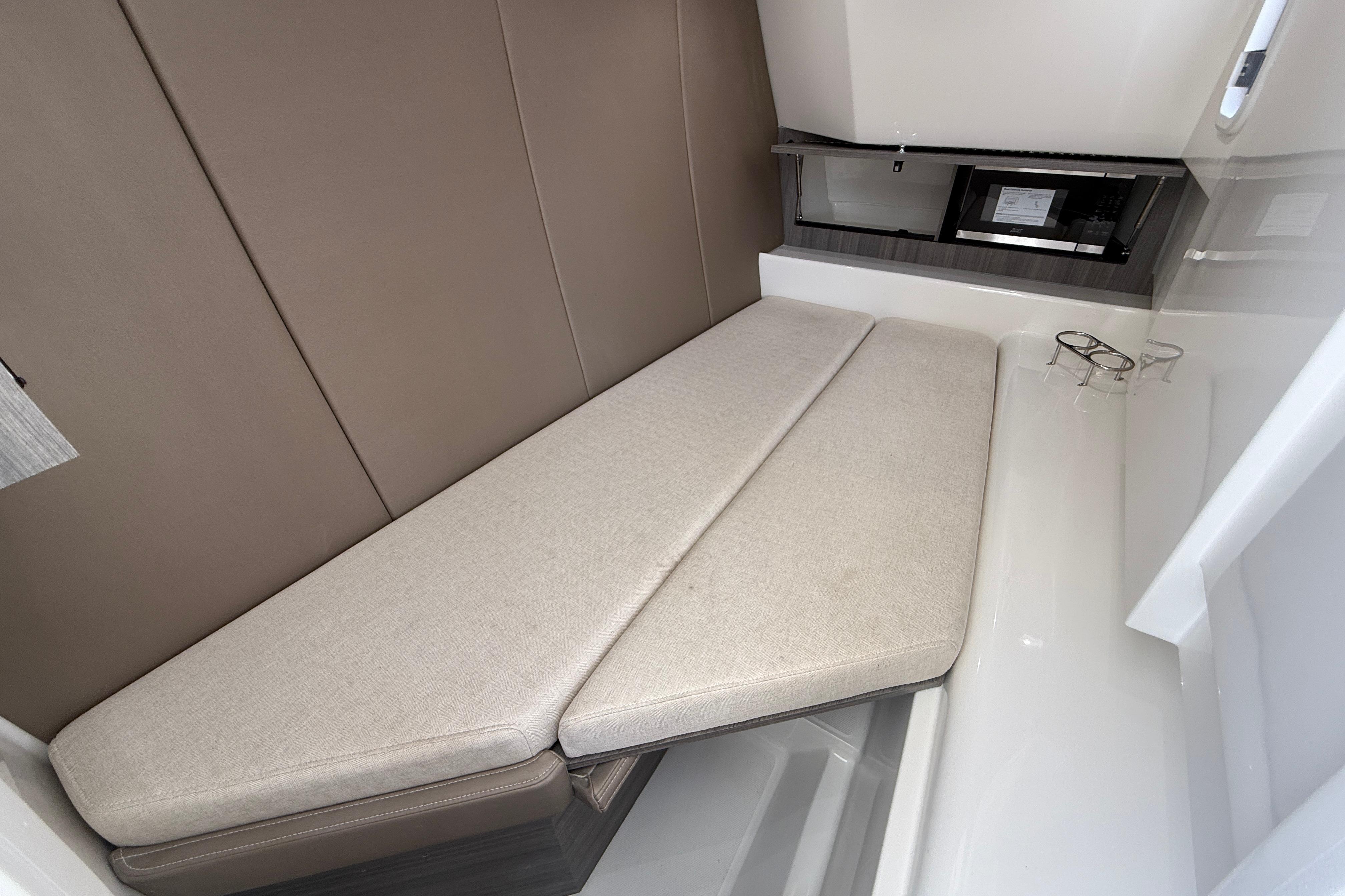 Interior cabin of 2026 World Cat 400 DC-X Island with beige seating.