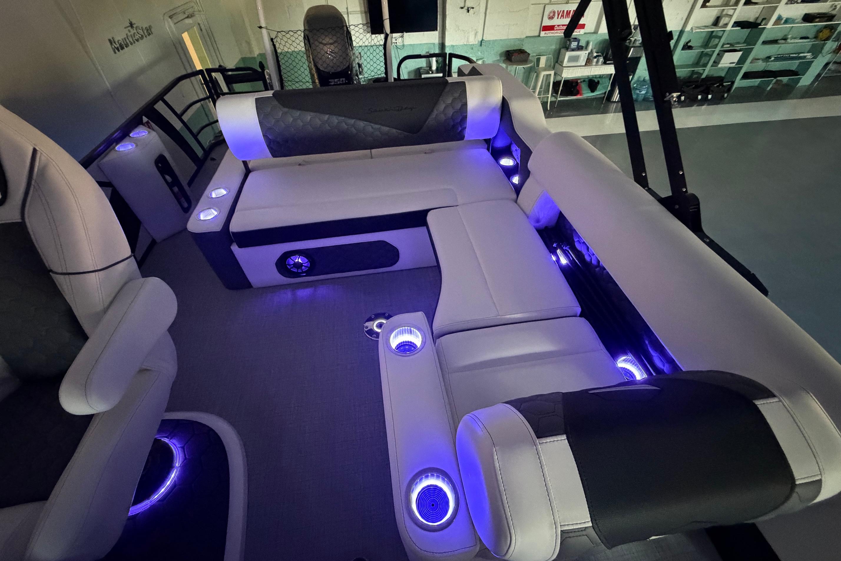 Luxurious interior of 2026 South Bay 525SB2 pontoon boat with ambient blue lighting.