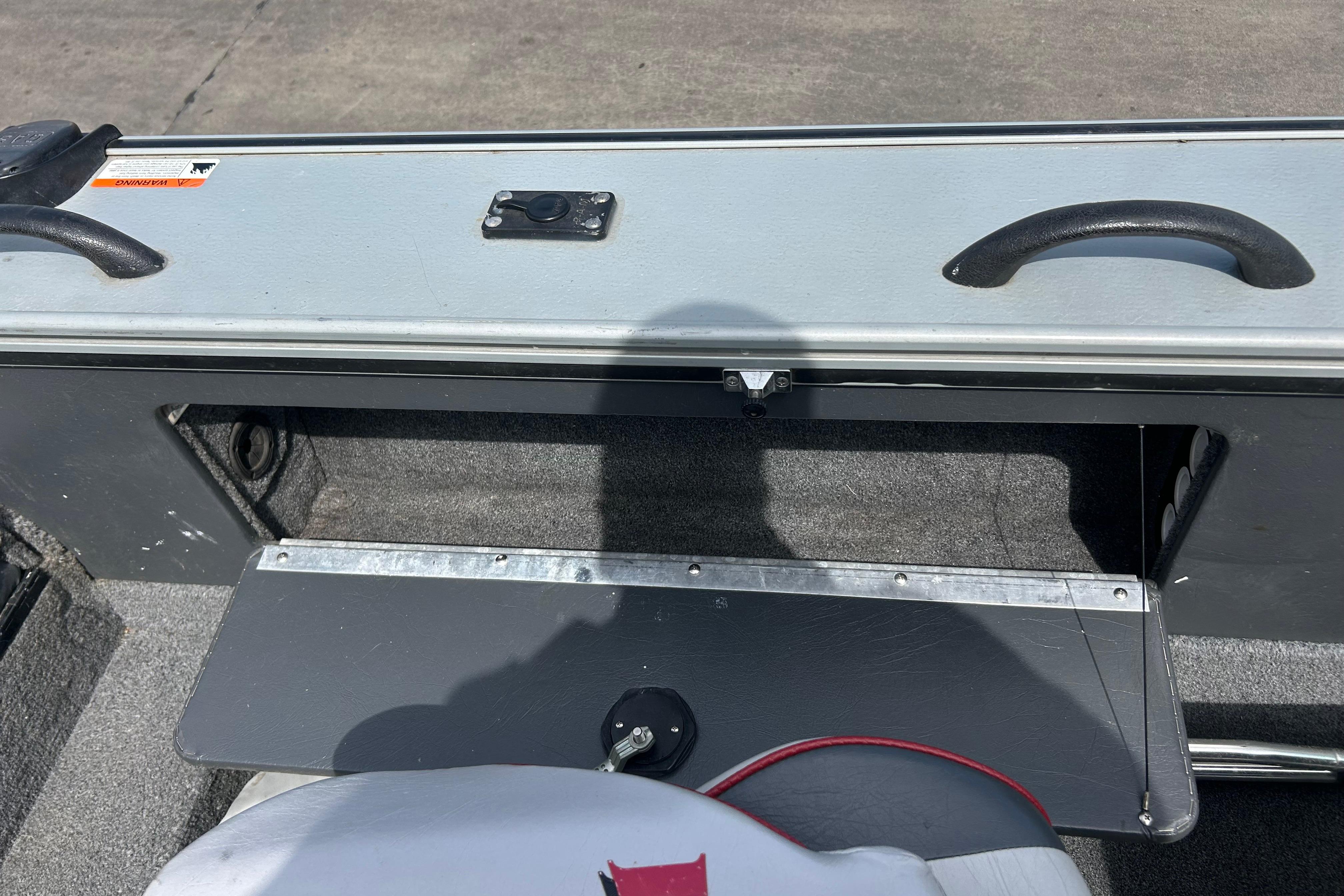 2008 Lund 1850 Fisherman boat interior with storage compartment and handles.