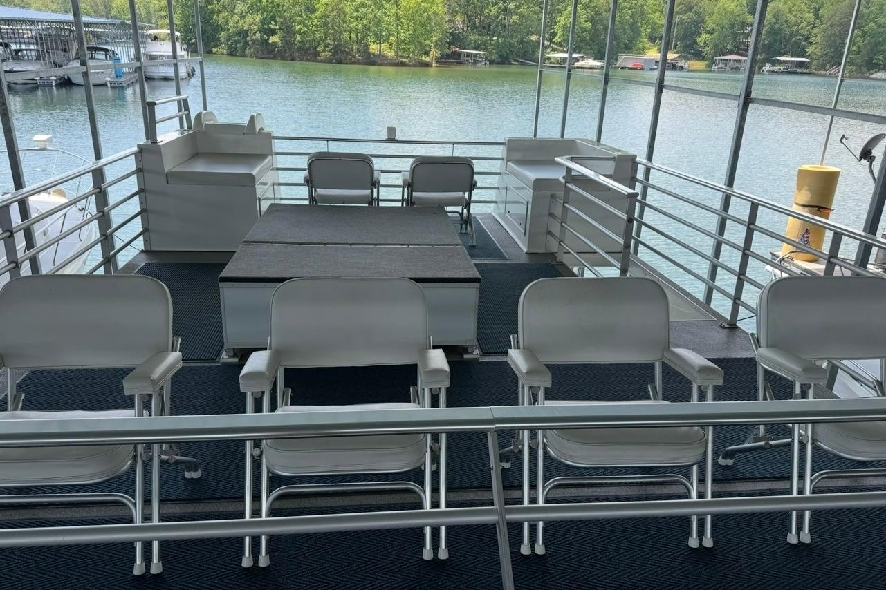 Upper deck of 2008 Destination Yachts 45X14, featuring seating and scenic lake view.