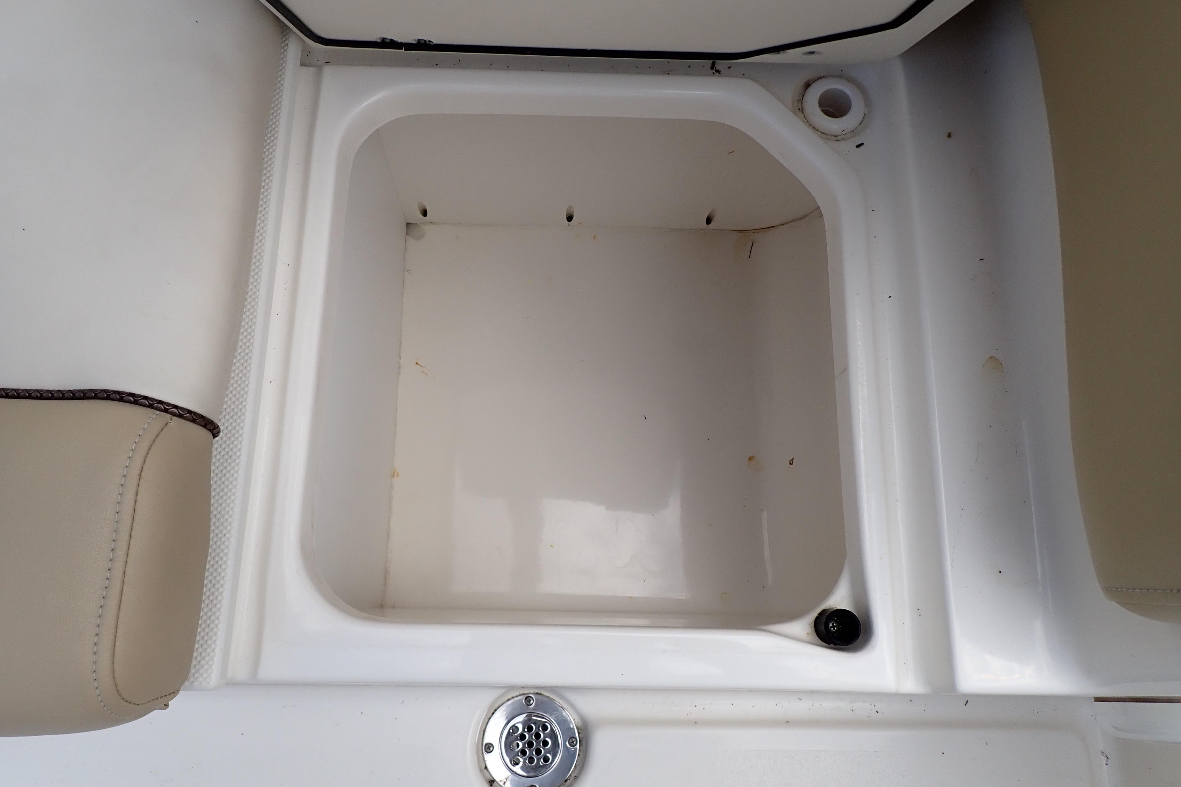 Storage compartment on a 2019 Key West 263 FS boat, featuring beige seating.