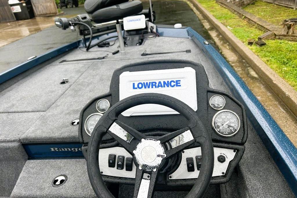 2026 Ranger RT188P boat dashboard with Lowrance electronics and steering wheel in a wet setting.