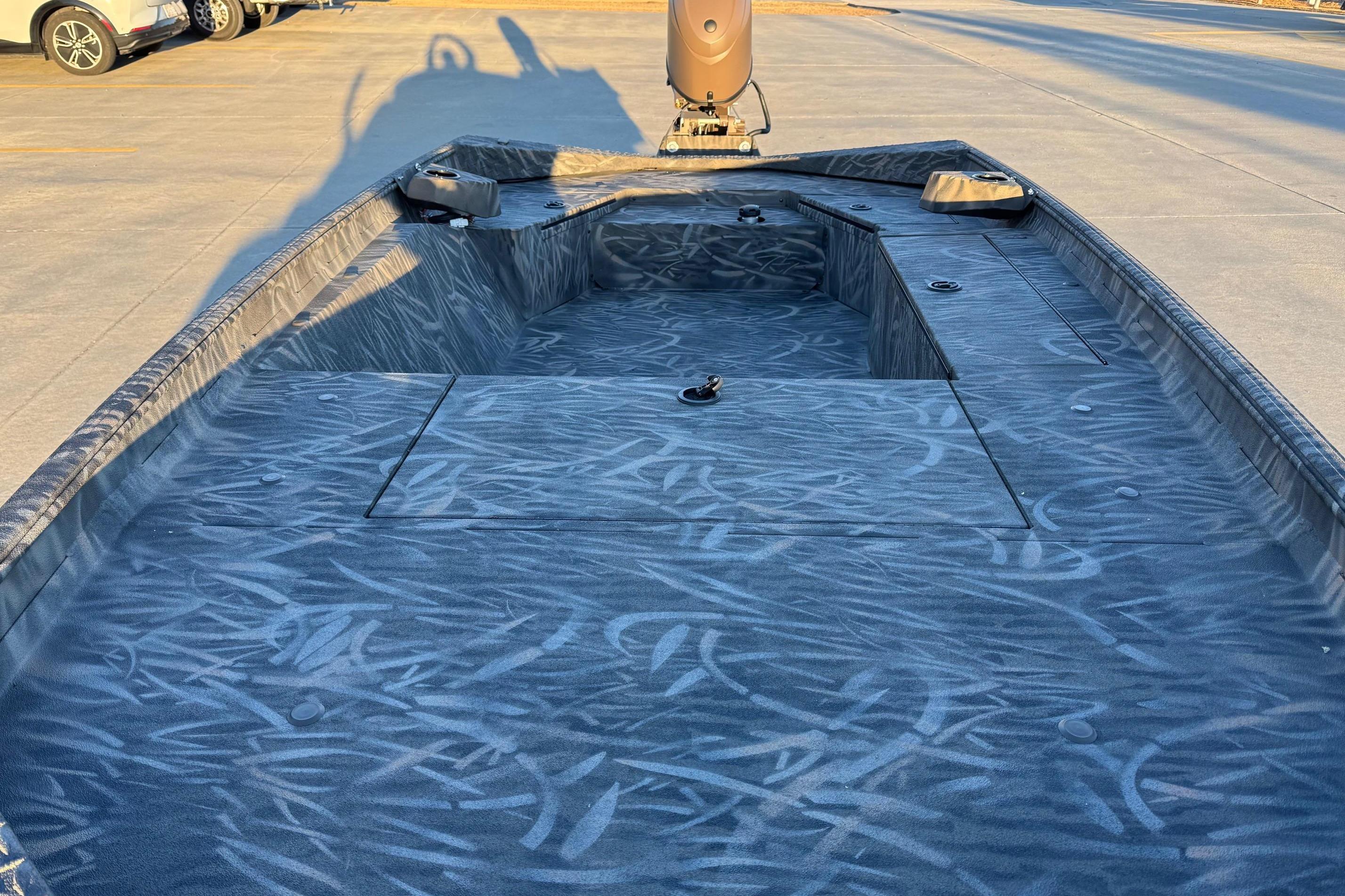 2026 Alweld 1652 Invader boat interior with textured flooring, parked outdoors.