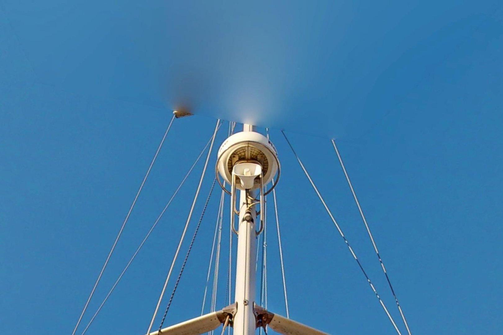 Mast of 1997 Hunter Legend 40.5 sailboat against clear blue sky.