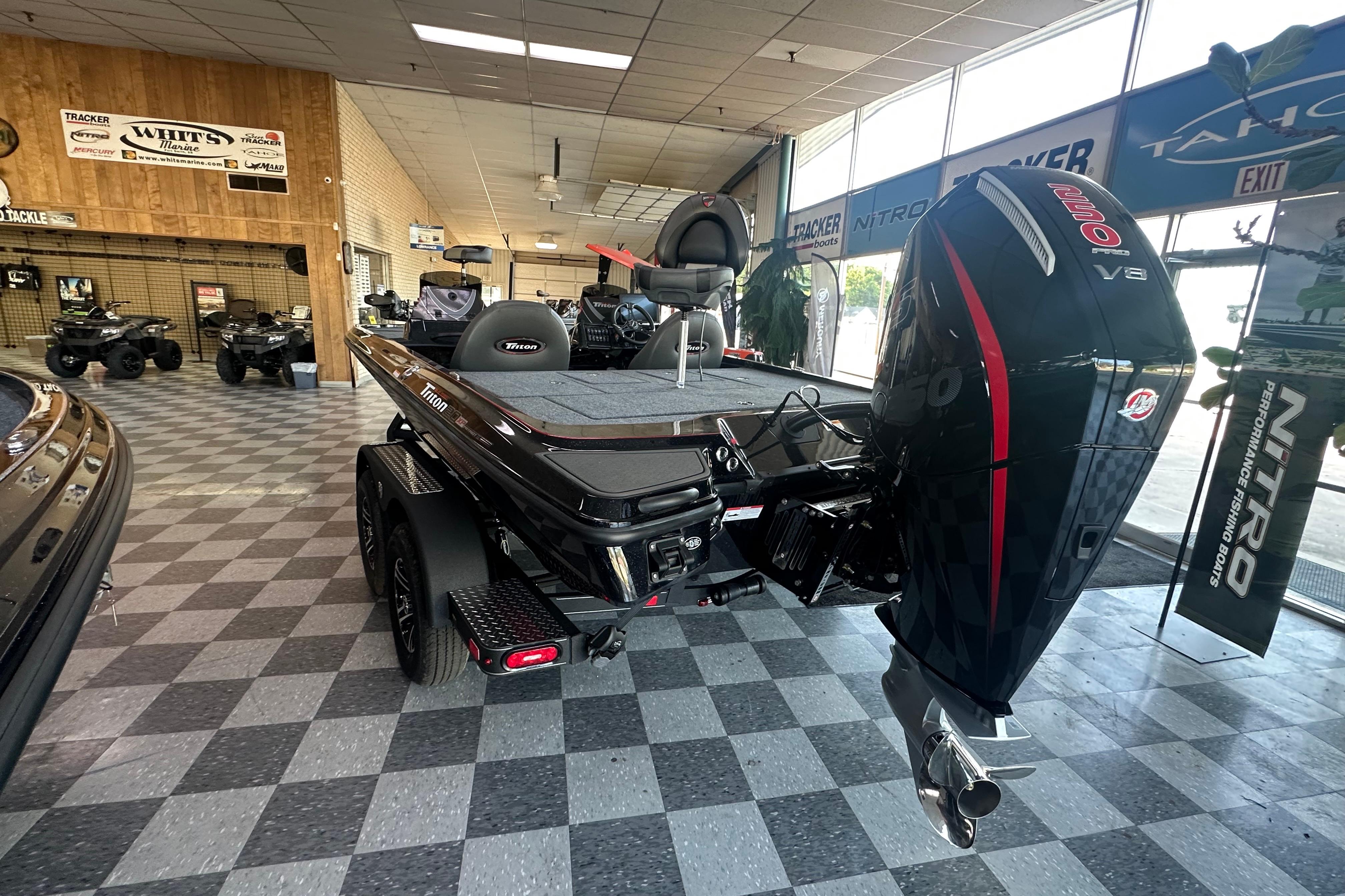 2026 Triton 20XP Patriot boat with powerful V8 engine displayed in showroom.