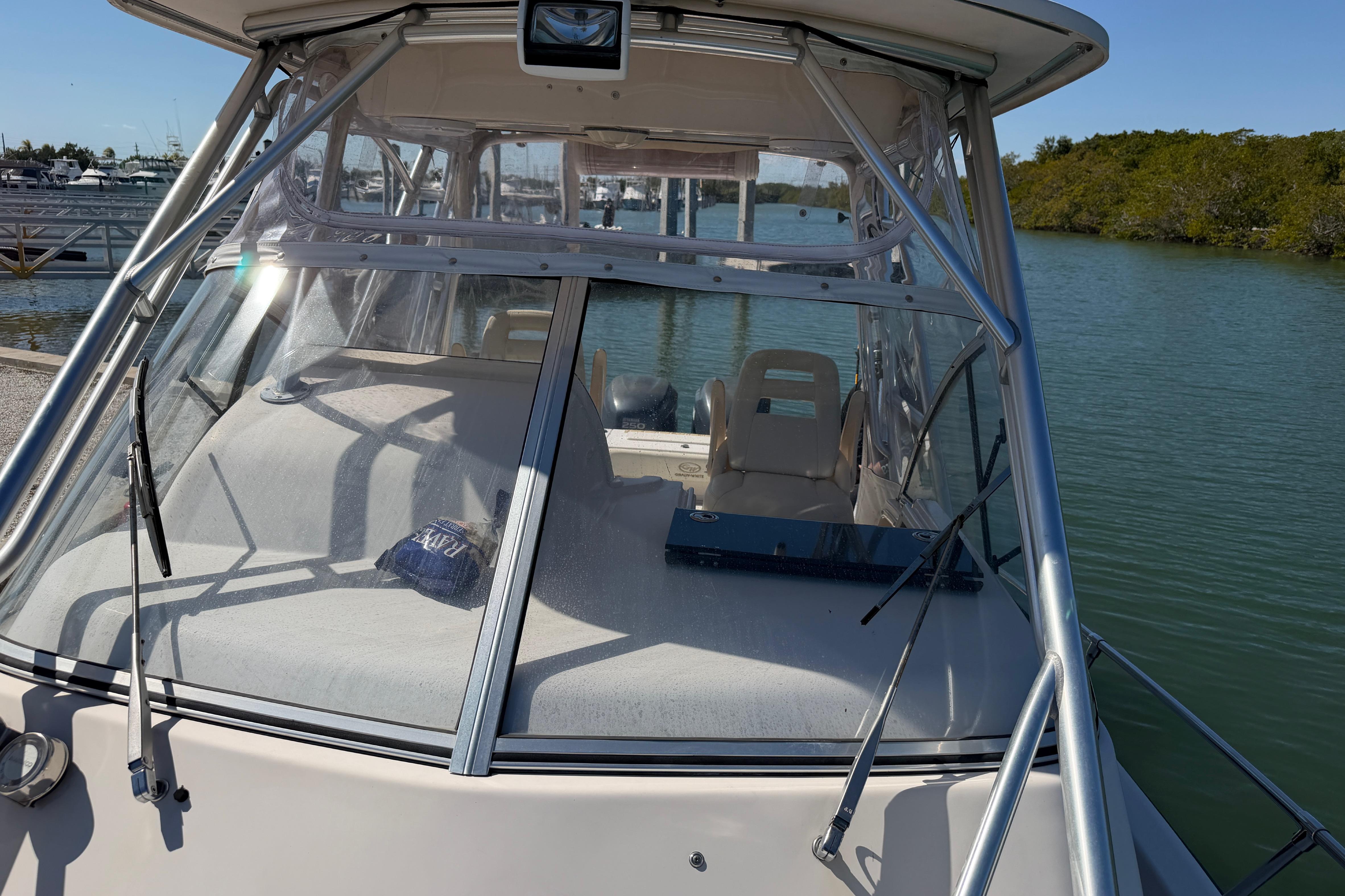 2006 Grady-White Sailfish 282 boat docked by the water, showcasing cockpit and windshield.