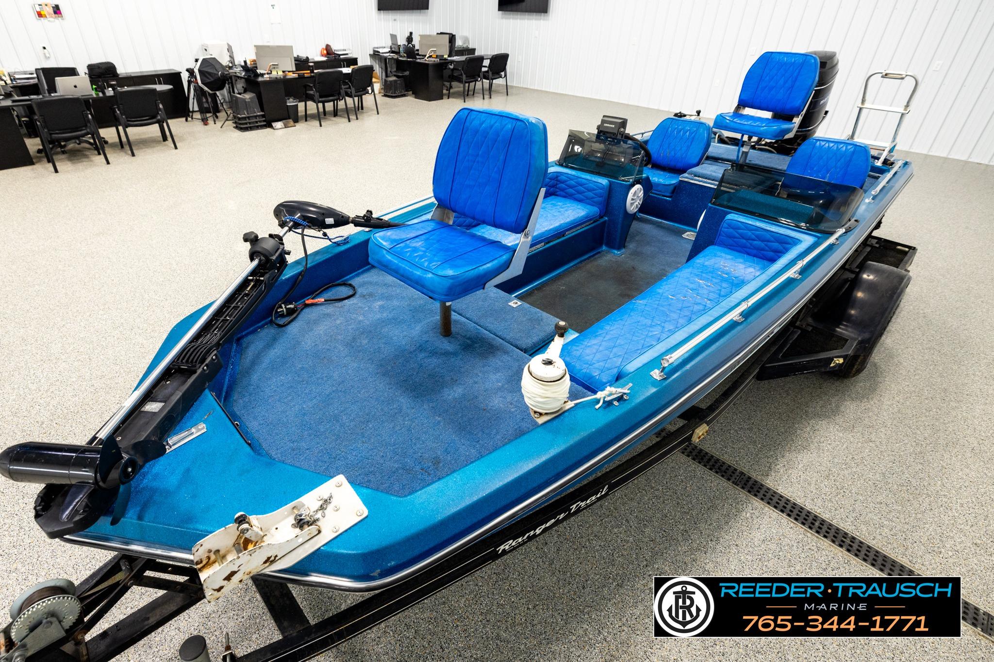 1980 Ranger 175 VS boat with blue seating, displayed indoors at Reeder Trausch Marine.