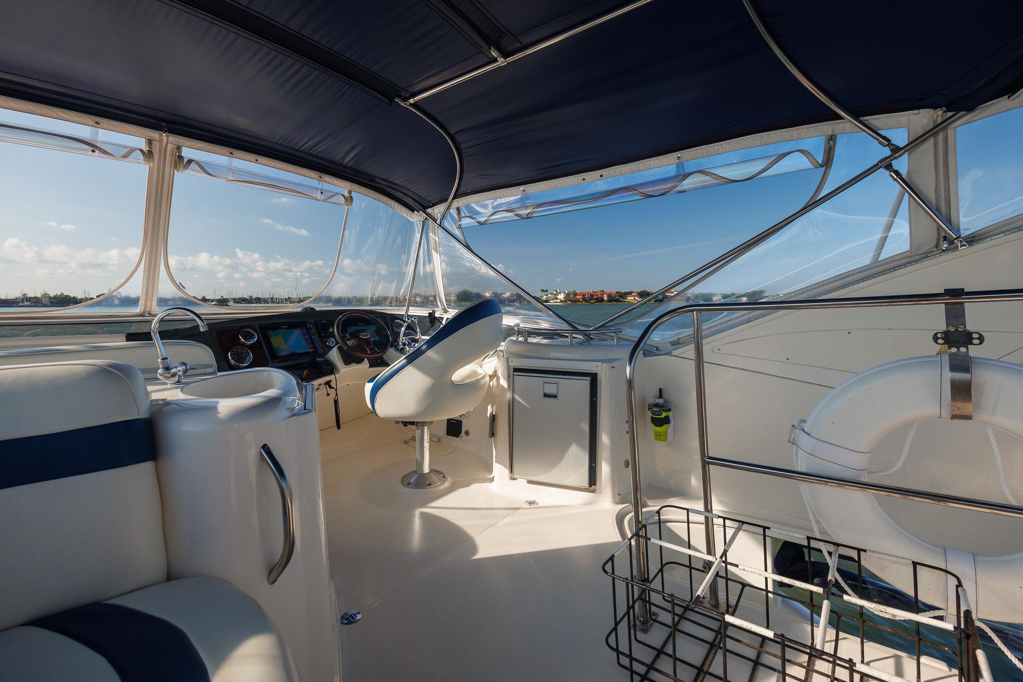 Interior view of 2010 Meridian 391 Sedan yacht cockpit with steering and seating.
