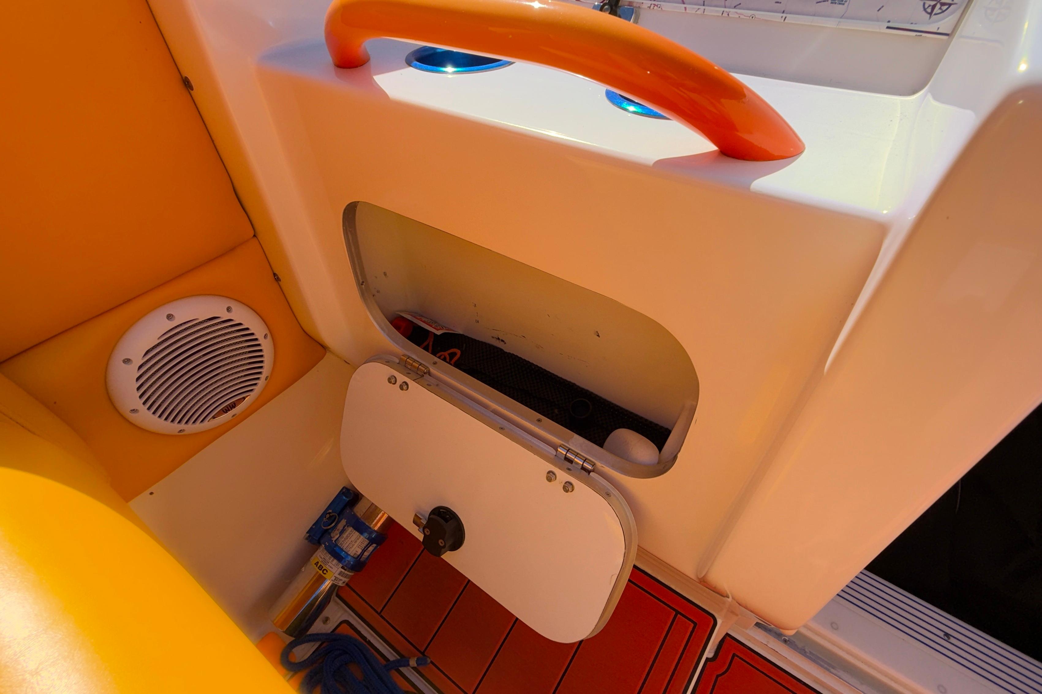 Storage compartment and speaker on 2002 Cigarette 35' Cafe Racer boat interior.