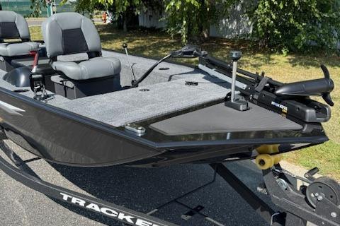 2026 Tracker Panfish 17 boat with seating and trolling motor, parked outdoors.