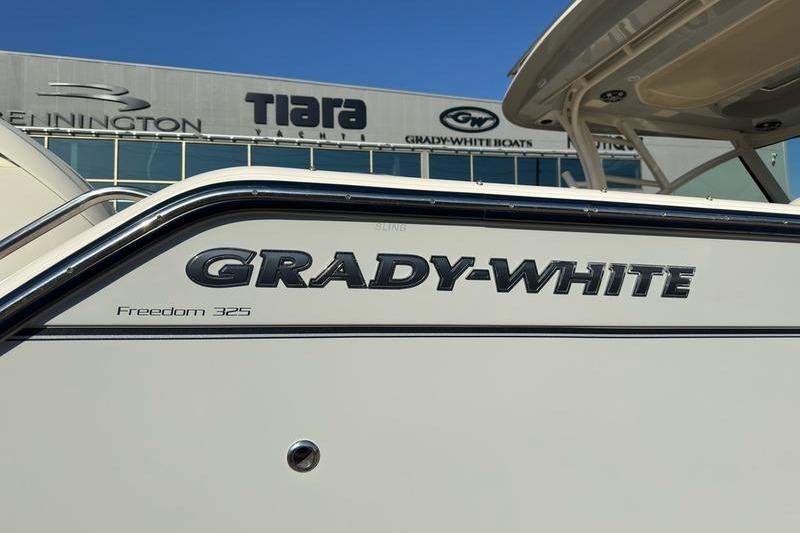 2025 Grady-White Freedom 325 boat exterior with logo and dealership background.