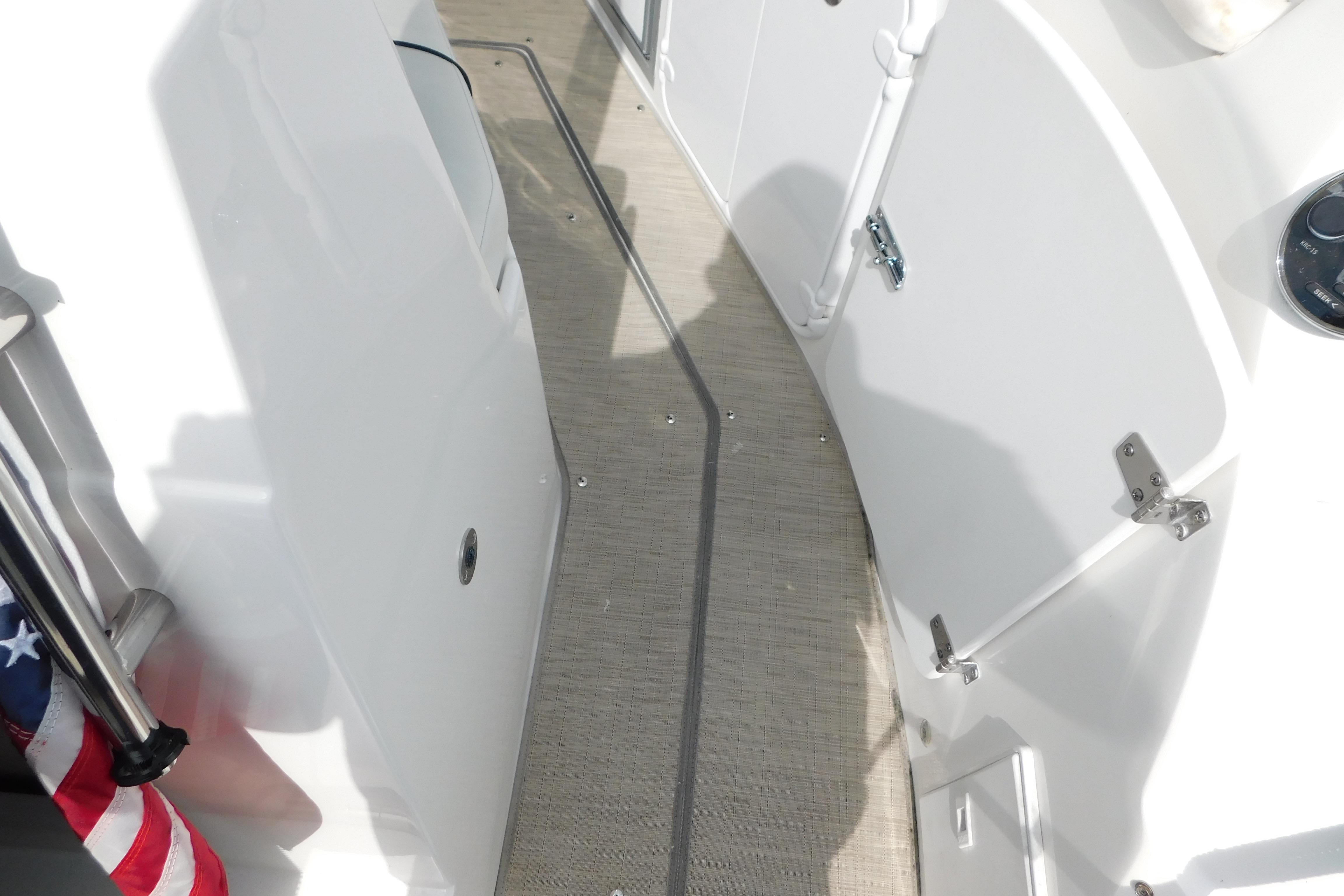 2017 Rinker EX 320 boat deck with white panels and American flag detail.