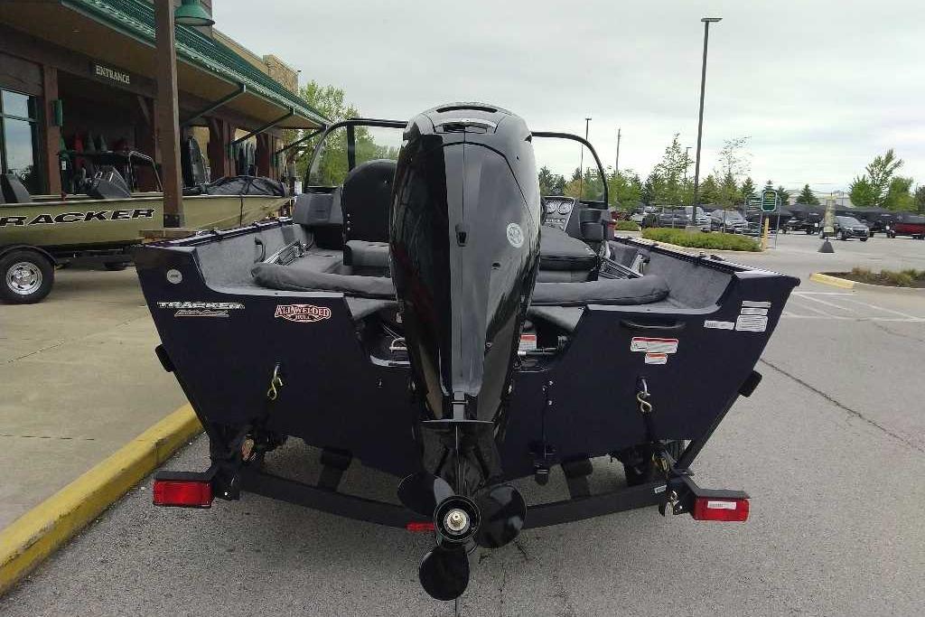 2026 Tracker Pro Guide V-16 WT boat with motor in parking lot.