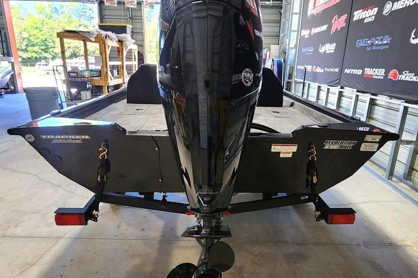 2026 Tracker Pro Team 175 boat in a showroom, rear view with motor.
