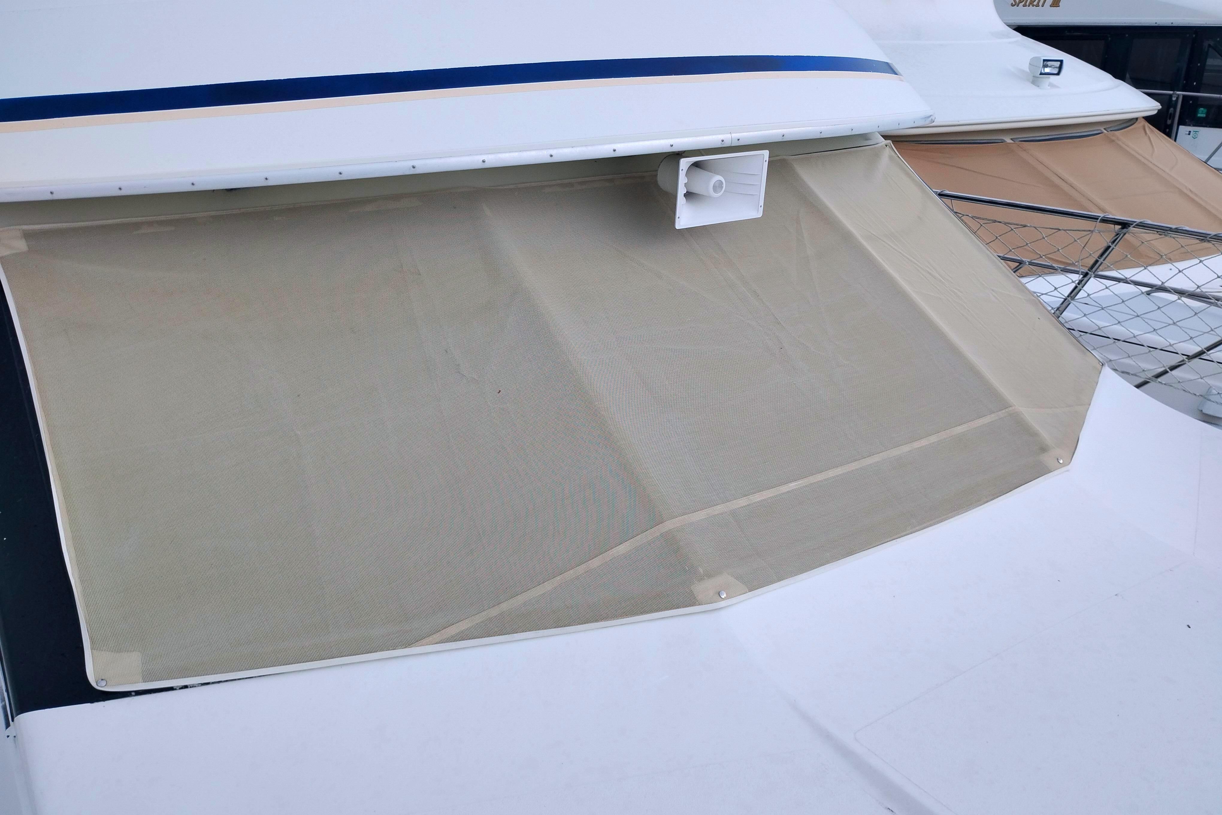 1991 Californian 52 Cockpit Motor Yacht with beige sunshade on deck.