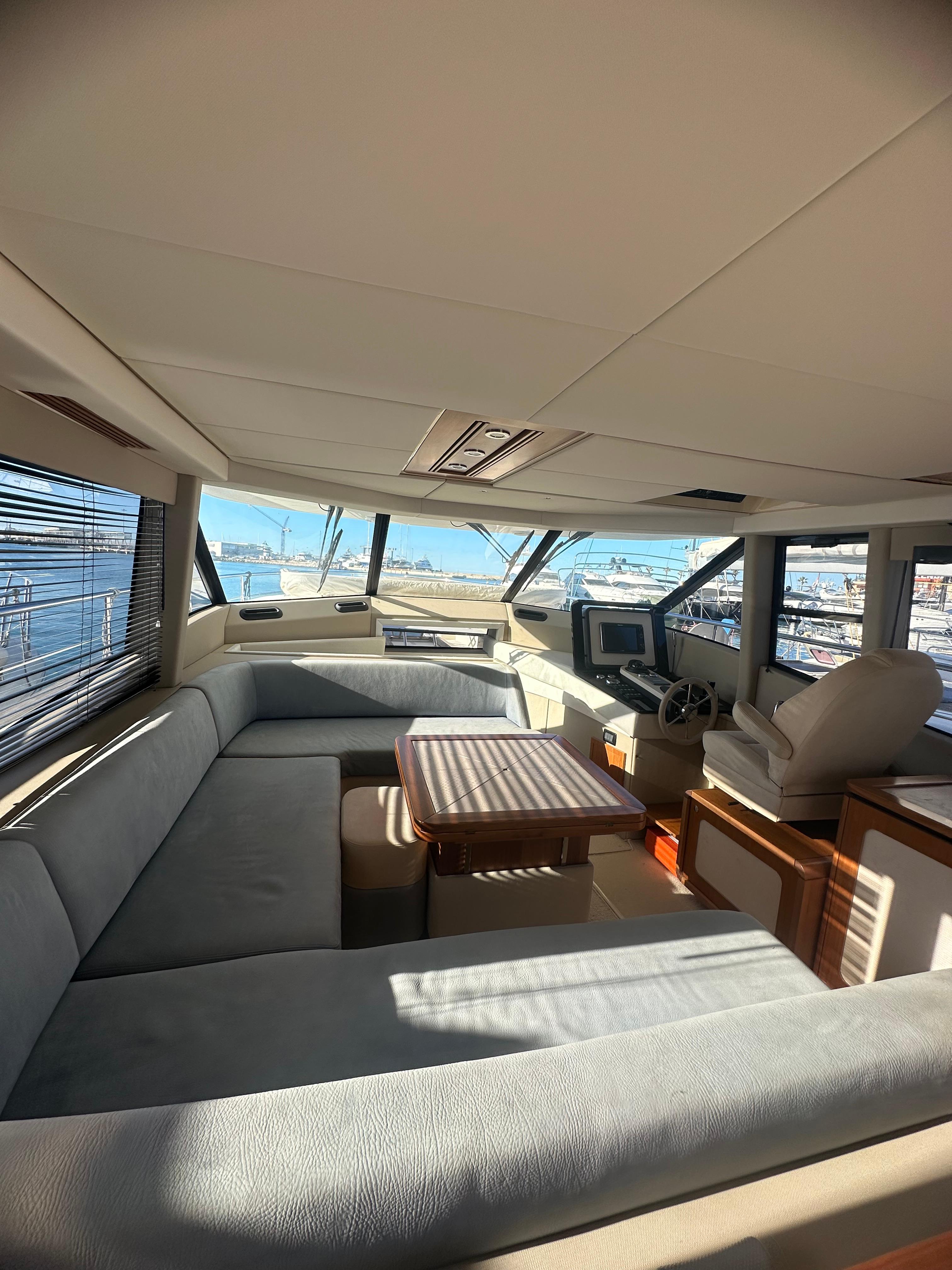 Luxurious interior of 2014 Azimut Magellano 50 yacht with panoramic windows and plush seating.