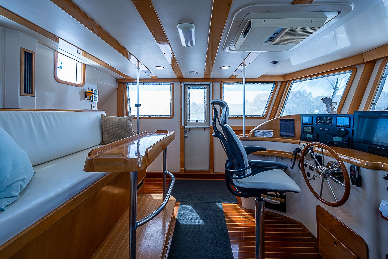 Interior of 2003 Magna Marine Nova Scotia 47, featuring helm, seating, and wooden accents.