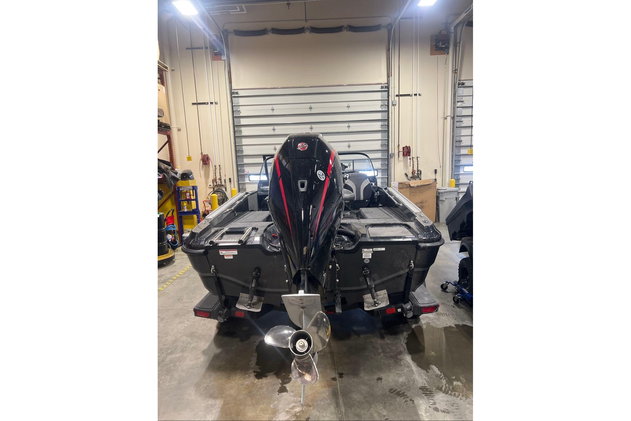 2026 Nitro ZV20 Pro boat in a garage, showcasing powerful outboard motor.