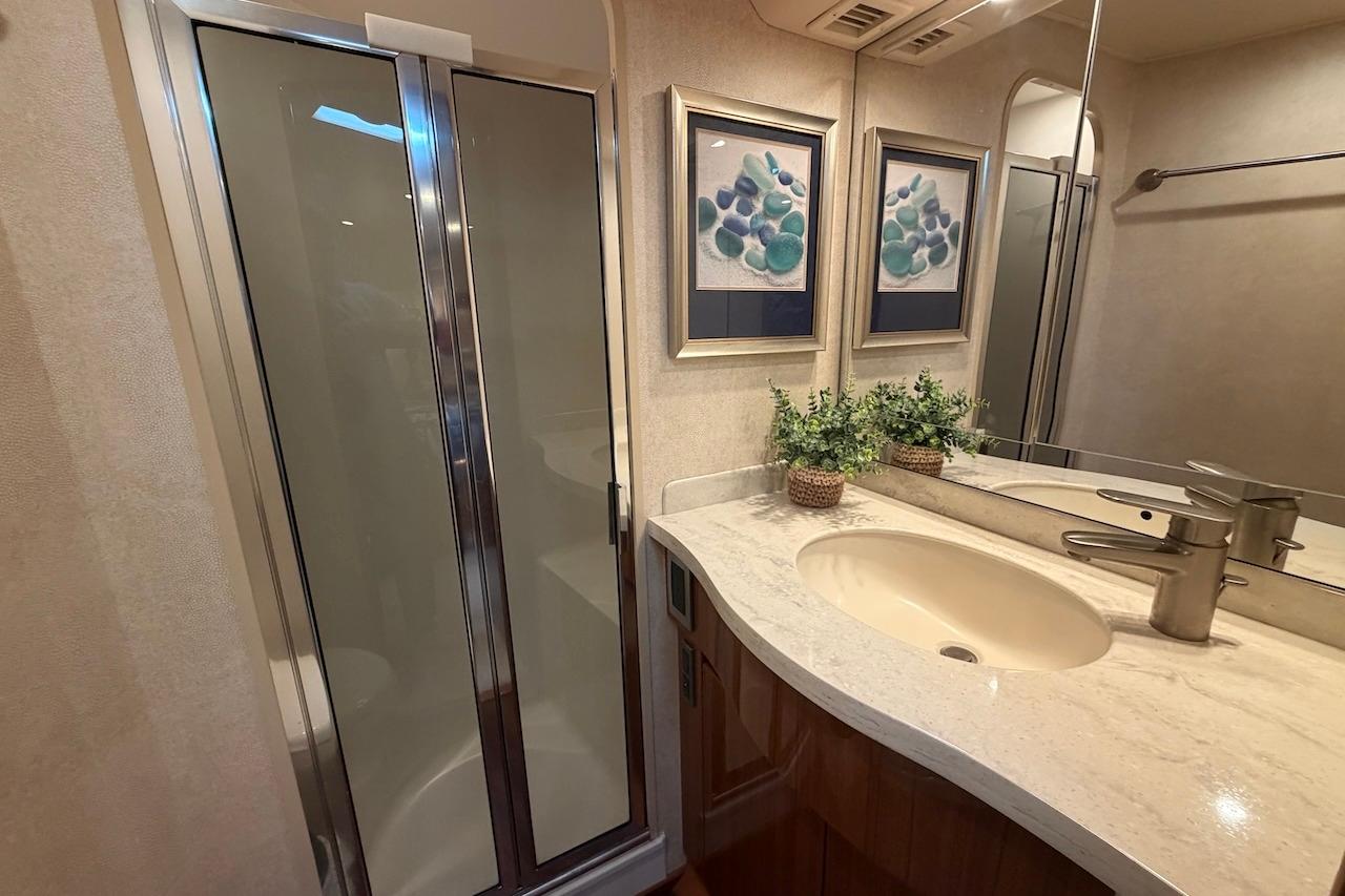 Luxurious bathroom in 2012 Viking 50 Convertible yacht with modern fixtures and elegant decor.