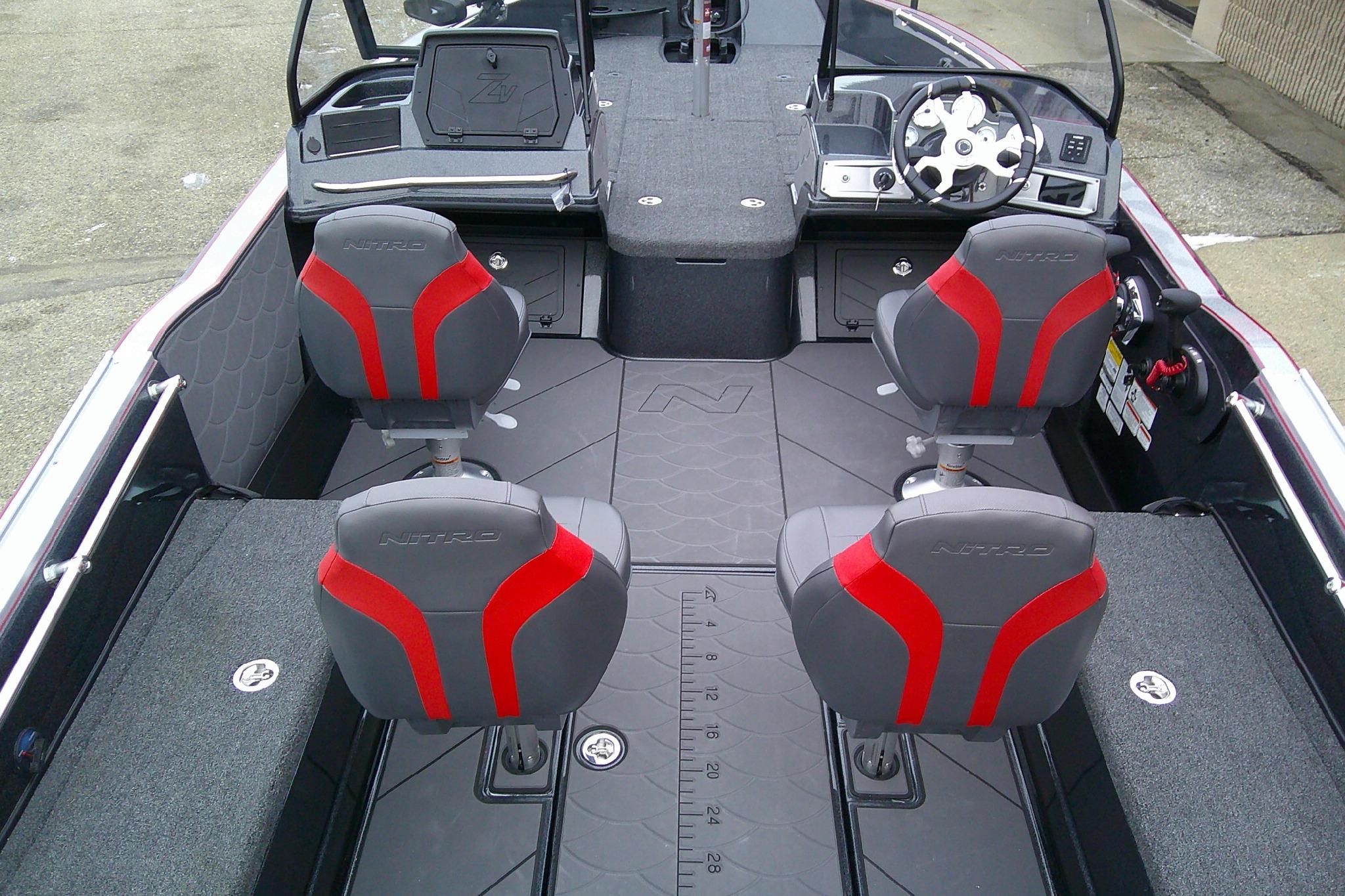 2026 Nitro ZV20 Pro boat interior with red and gray seats, steering wheel, and deck.