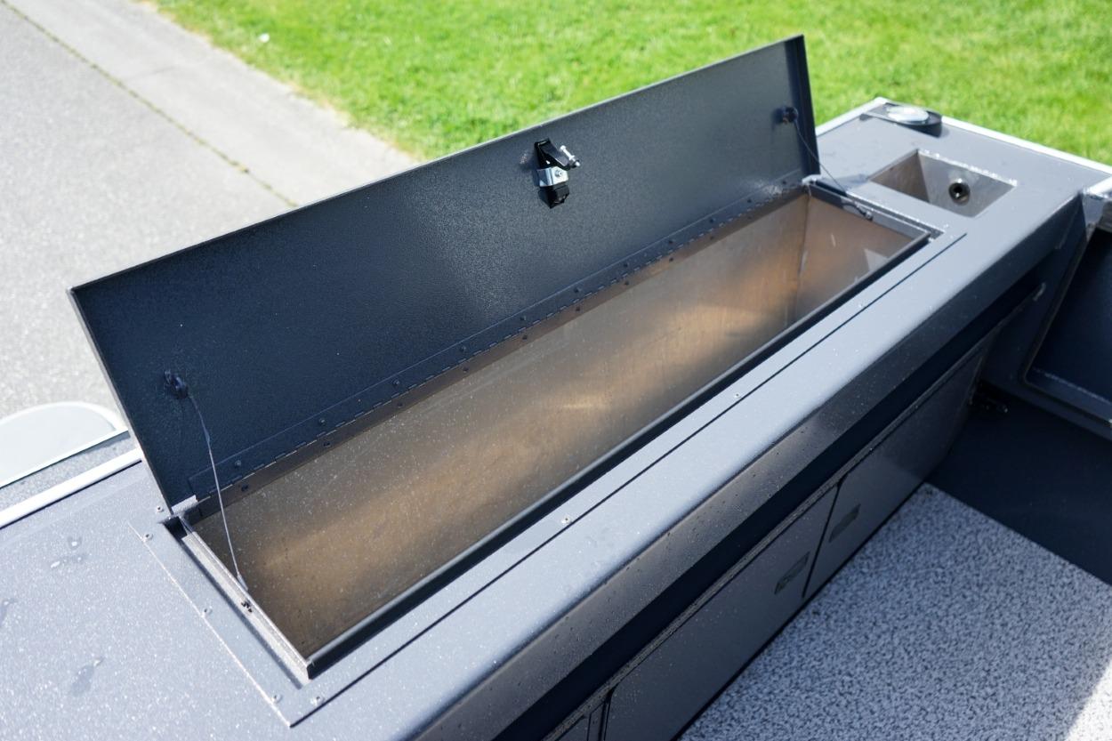 2026 Alumaweld X202 Styker boat storage compartment open, showcasing interior space.