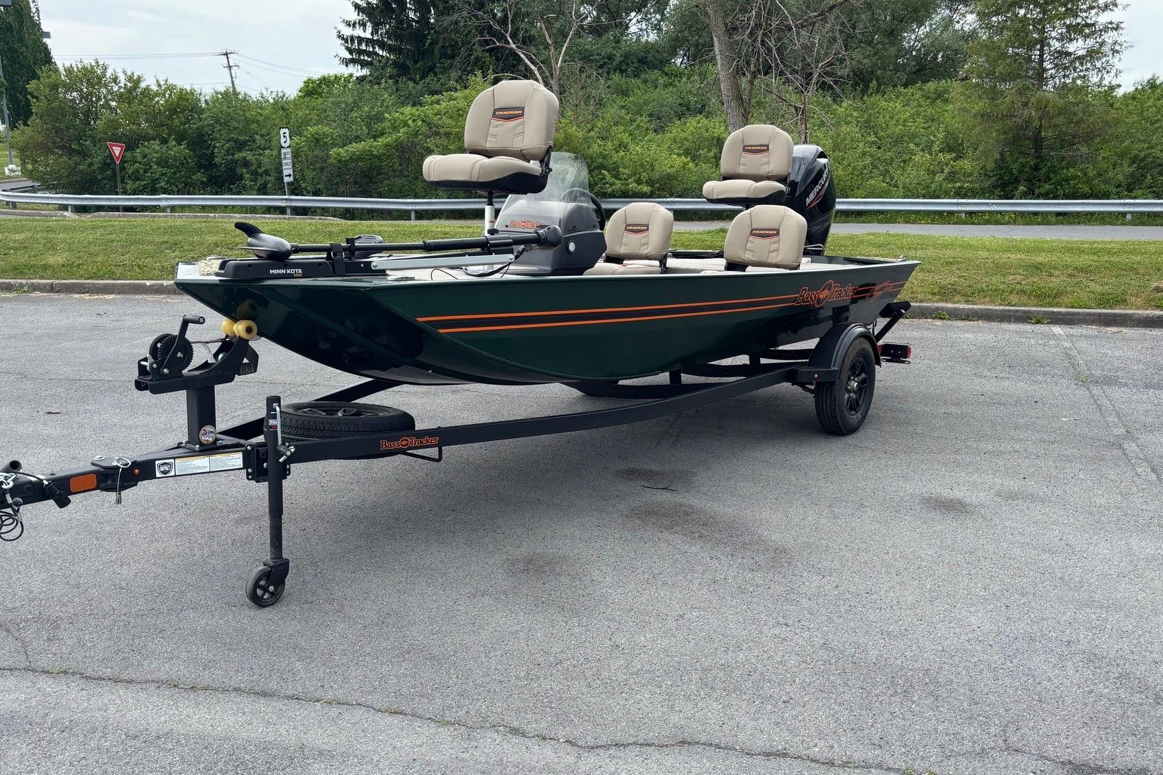2026 Tracker Bass Tracker Classic Limited fishing boat on trailer in parking lot.
