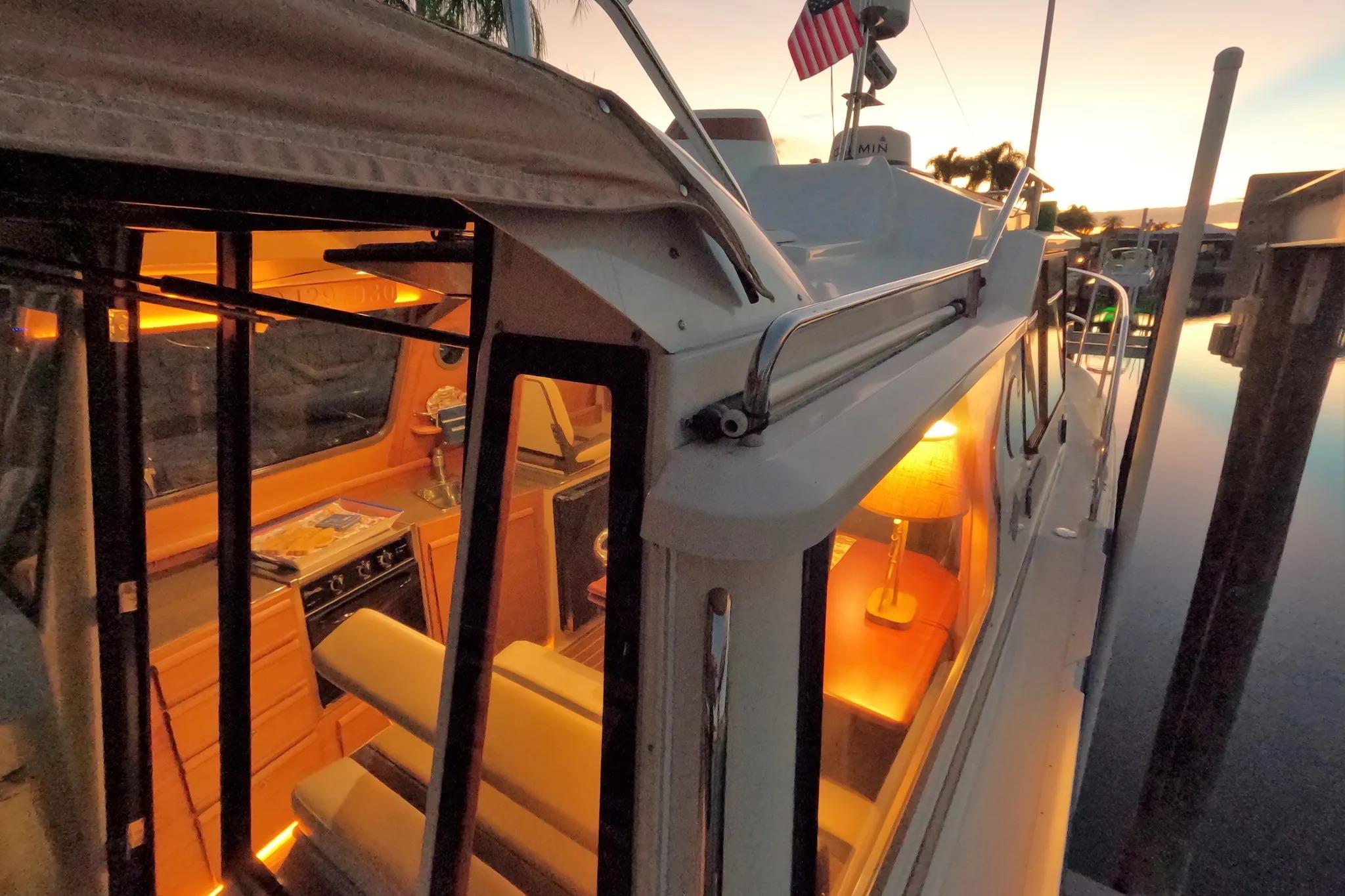 2015 Ranger Tugs R-29 S boat interior at sunset, warm lighting, docked.
