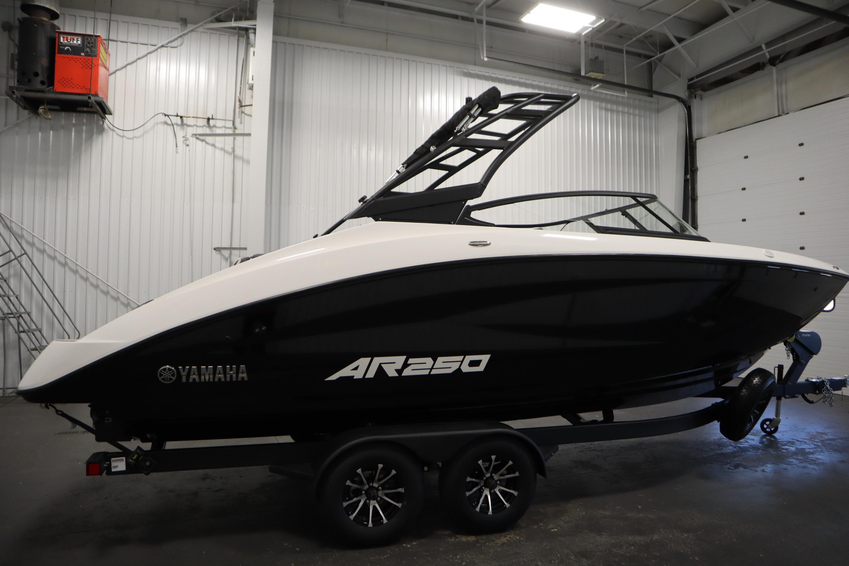 2026 Yamaha AR250 boat in a garage, sleek black and white design.