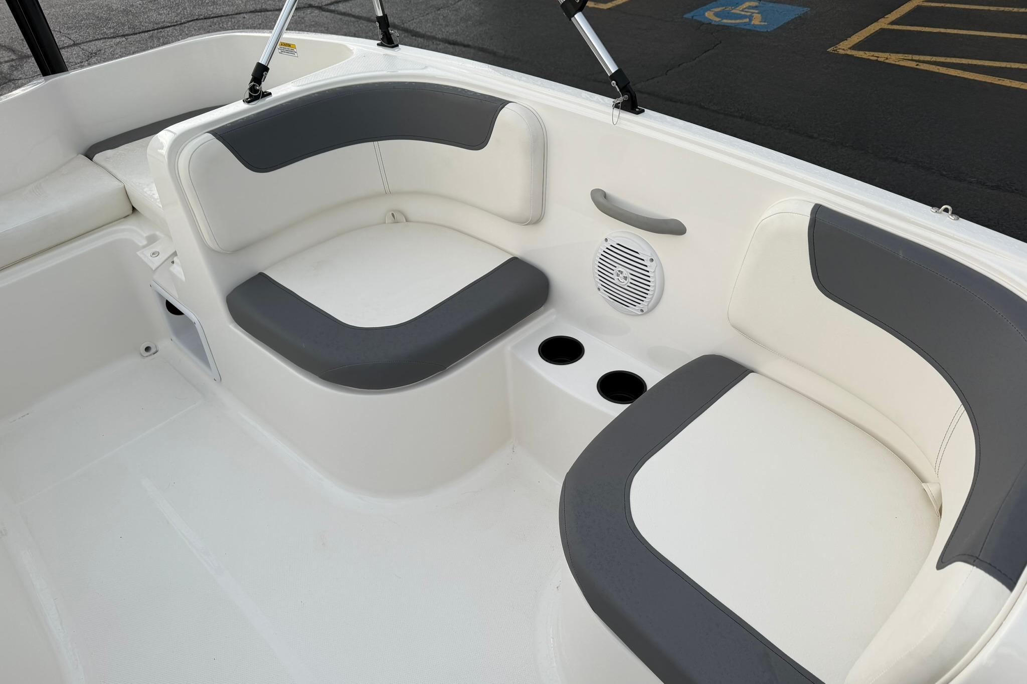 2026 Bayliner Element E16 boat interior with cushioned seating and cup holders.