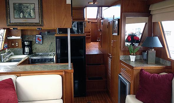 Interior of 1986 Sea Ranger 47 Pilothouse with kitchen and cozy seating area.