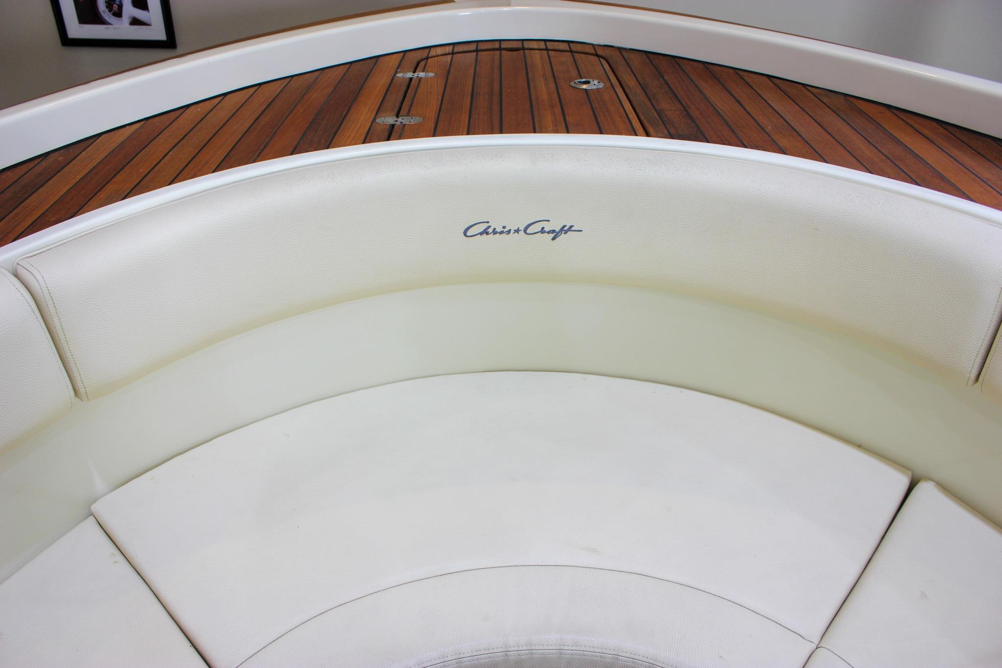 2018 Chris-Craft Calypso 30 boat interior with white seating and wooden deck.