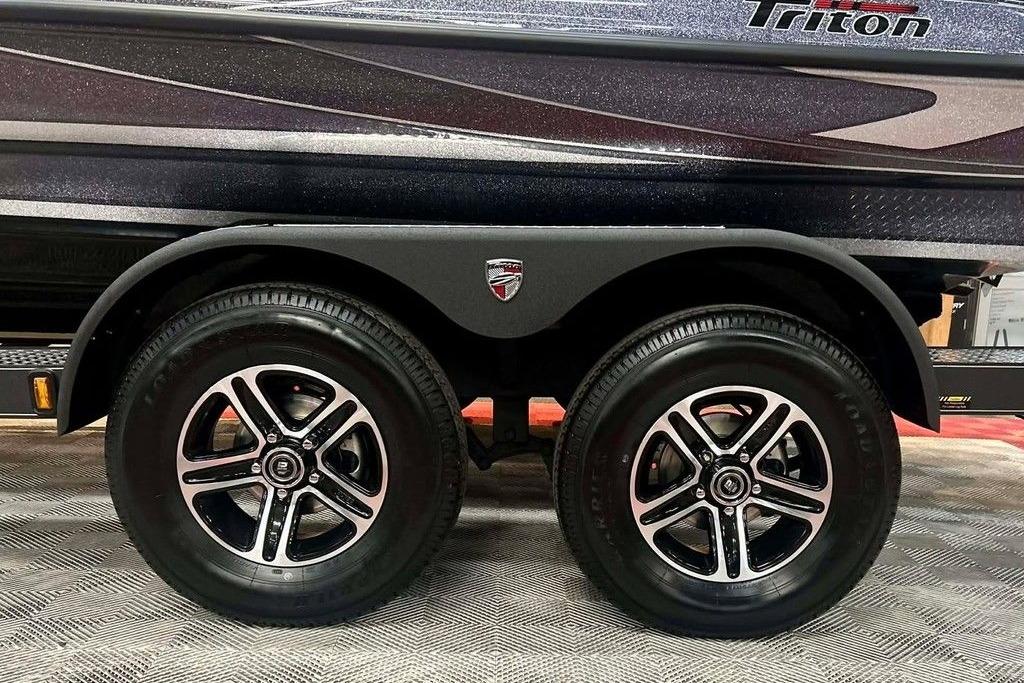 2026 Triton 18 TrX boat trailer with dual black alloy wheels.