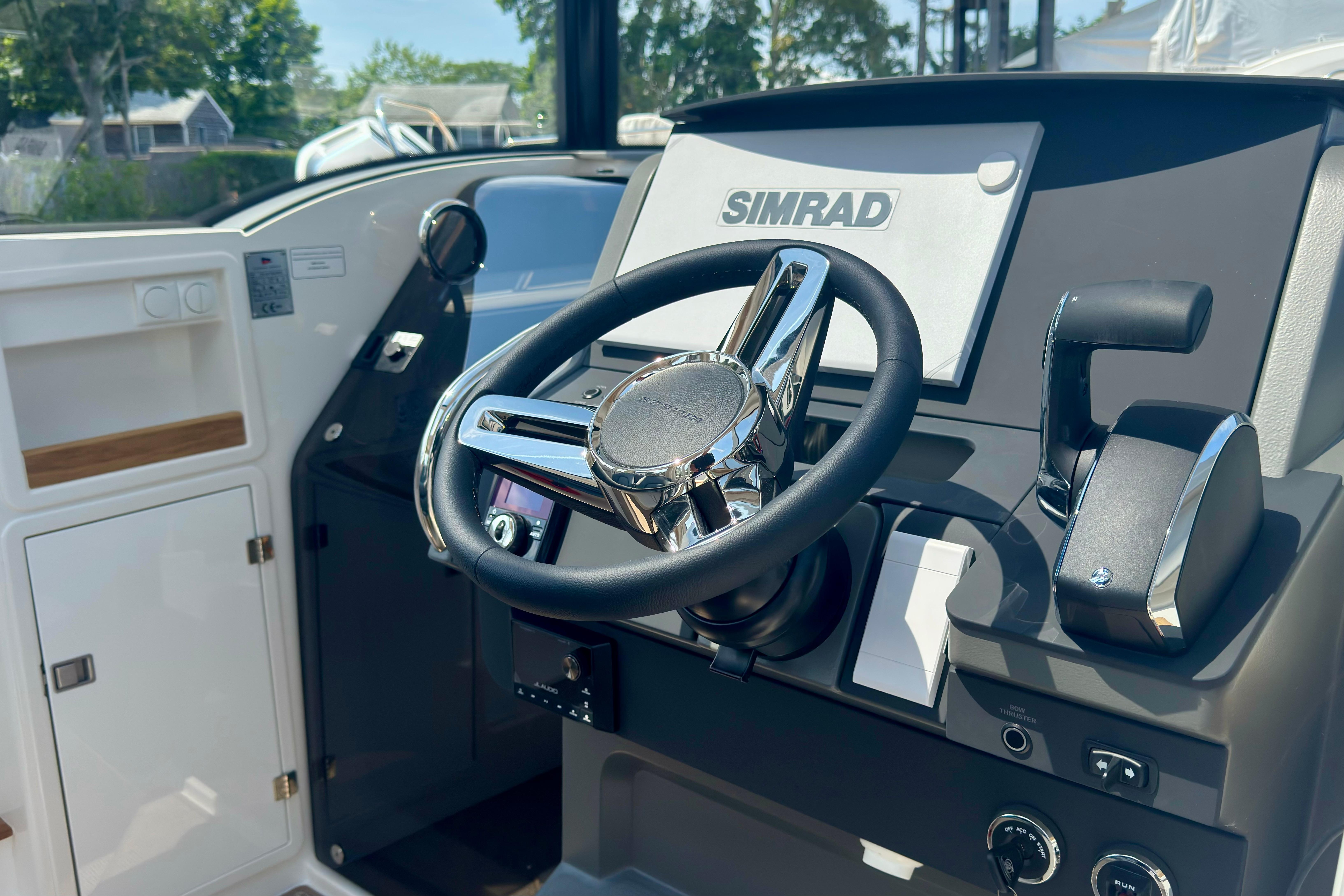 The image shows the helm of a 2026 Nimbus Commuter 9 with a Simrad display.