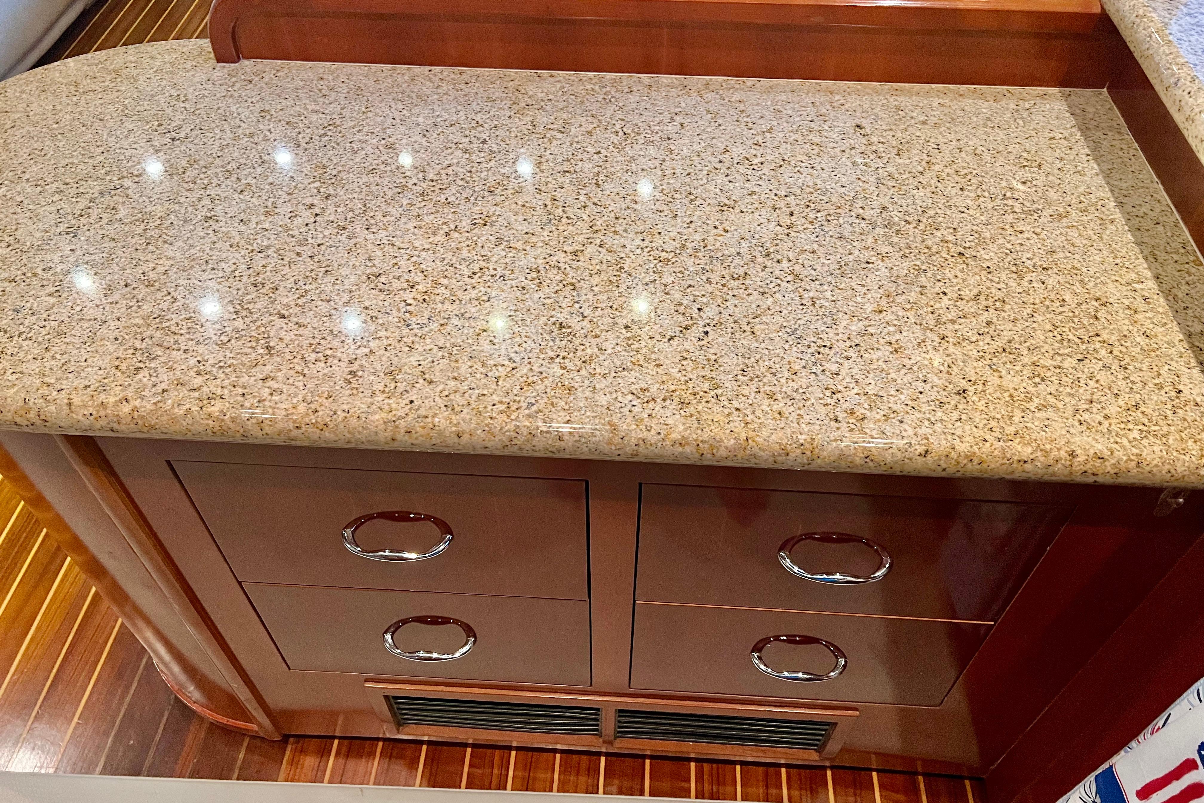 Granite countertop with wooden drawers in 2005 Carver 56 Voyager yacht interior.