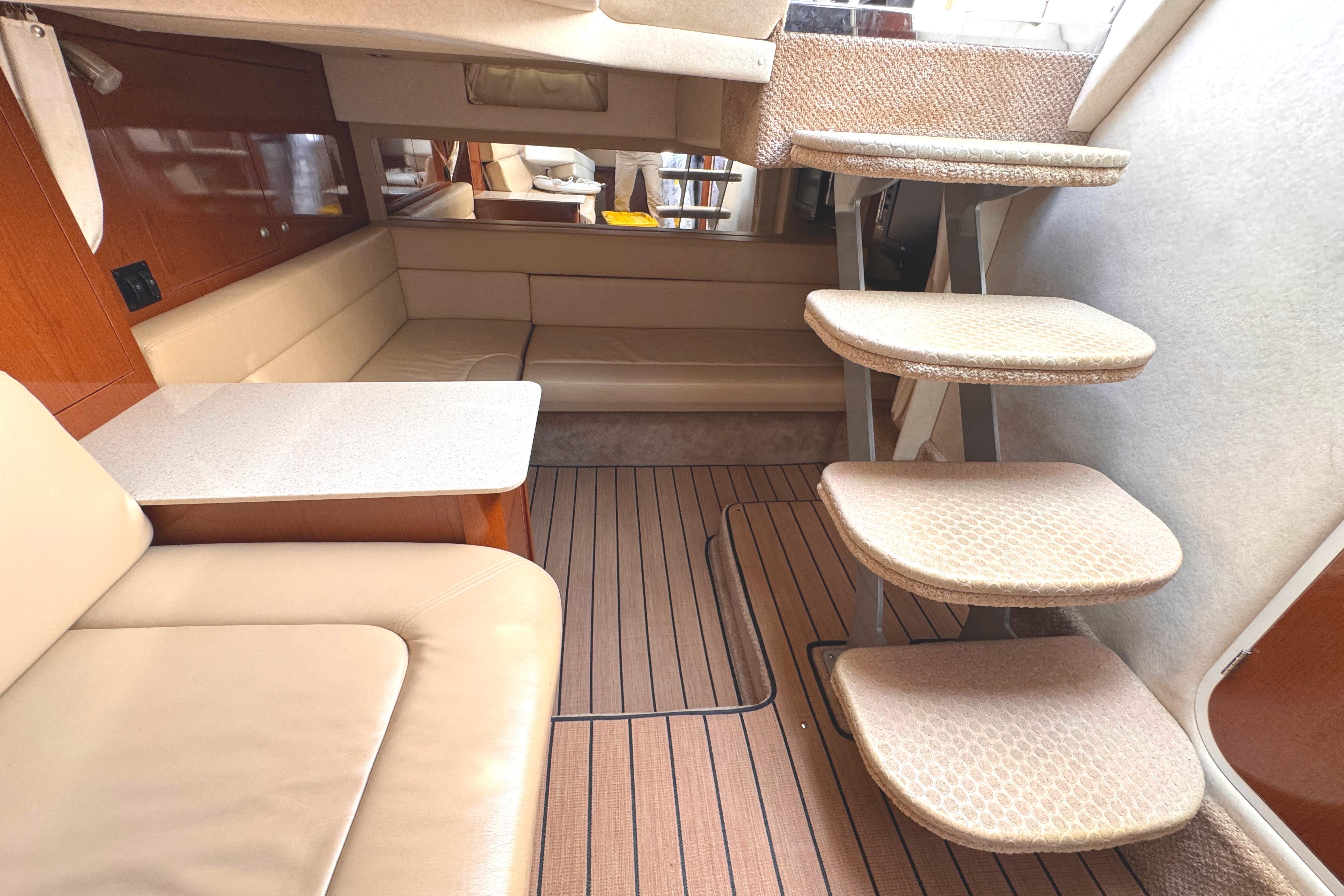 Interior of 2008 Sea Ray Sundancer 350 yacht with beige seating and wooden flooring.