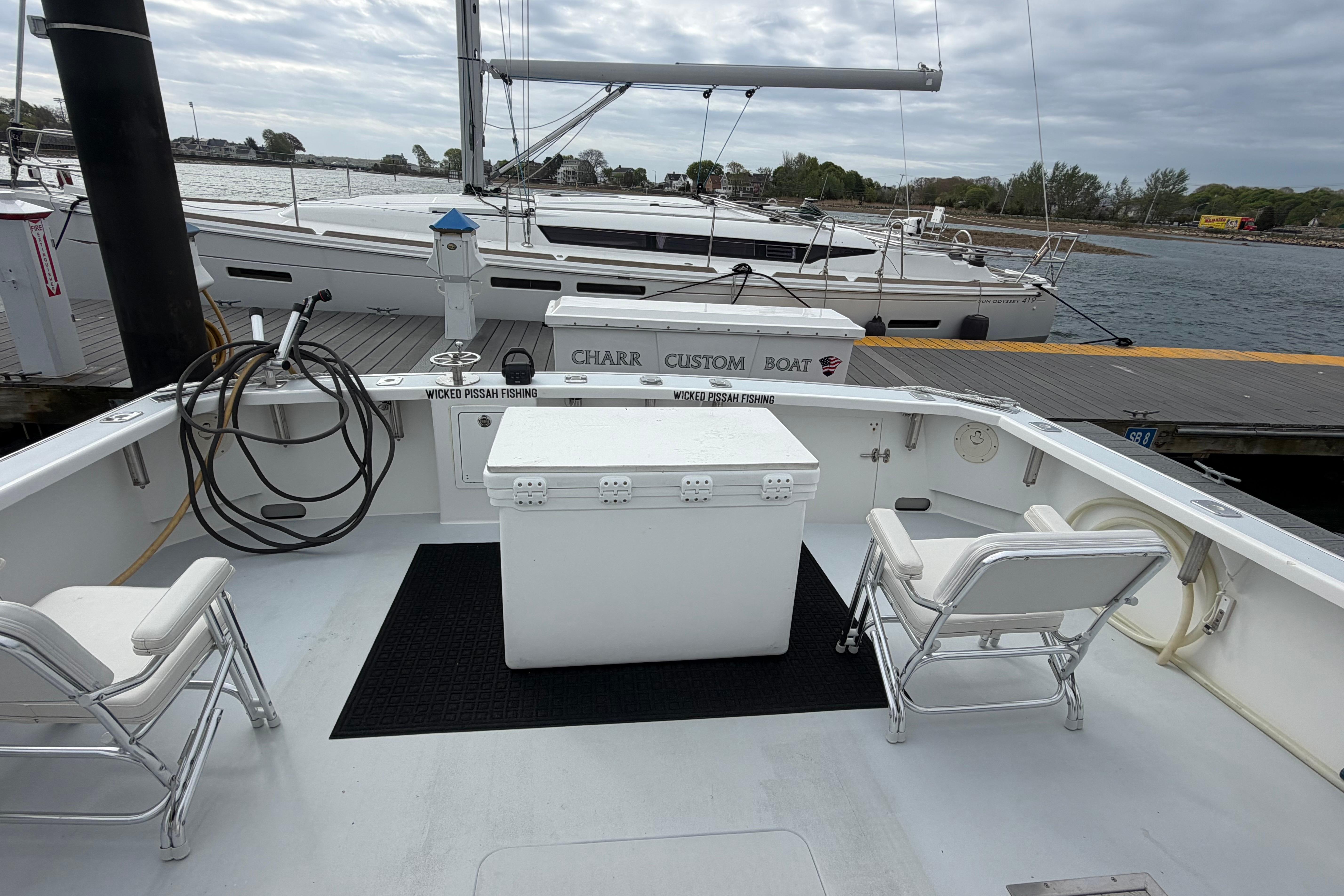 2018 H&H Marine Osmond Beal boat docked, featuring spacious deck and seating.