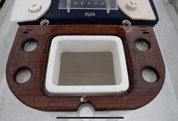 1979 Chaparral 224 Fisherman boat console with wooden trim and cup holders.