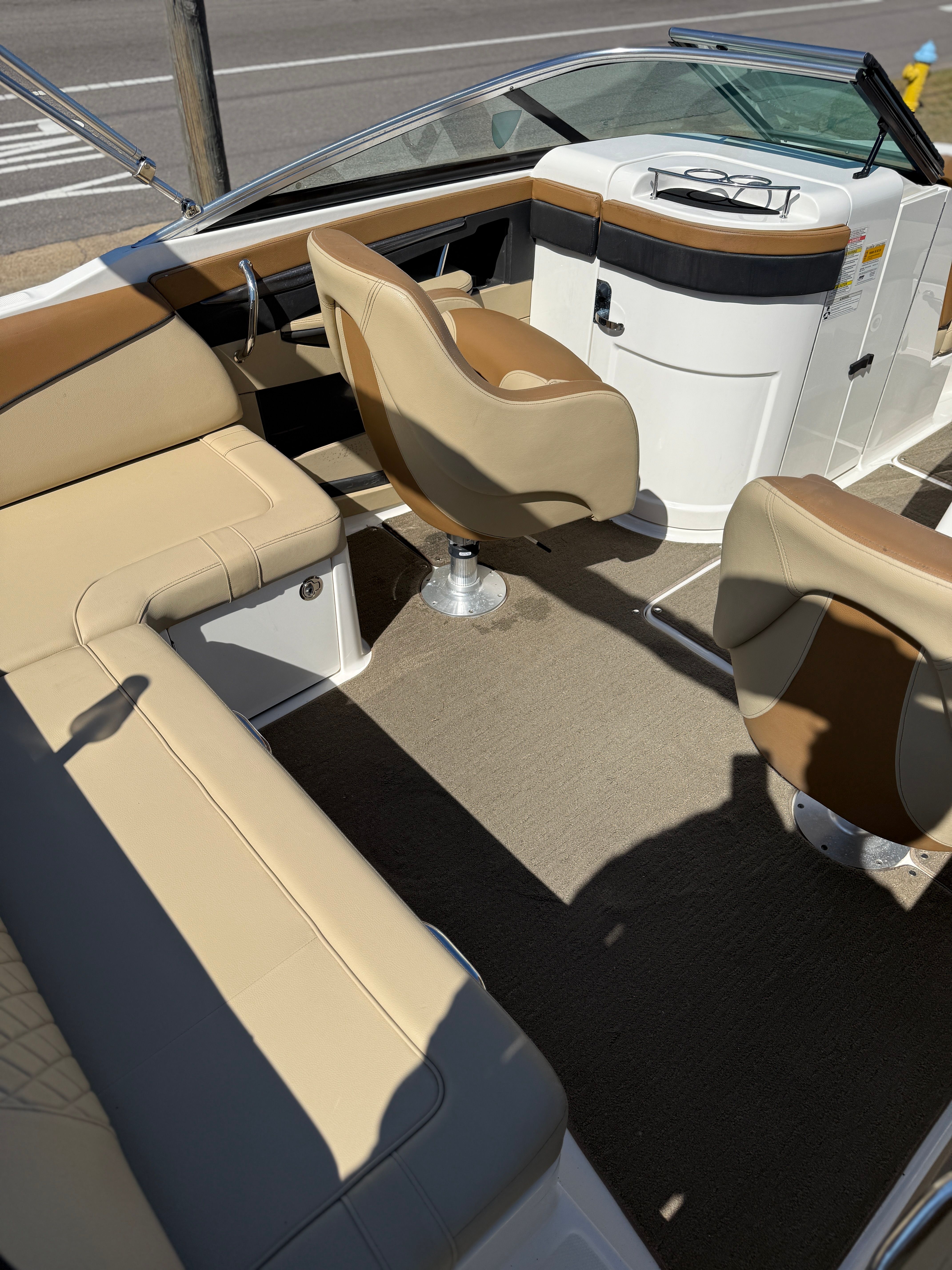 Interior of a 2015 Sea Ray 220 Sundeck OB with beige seating.