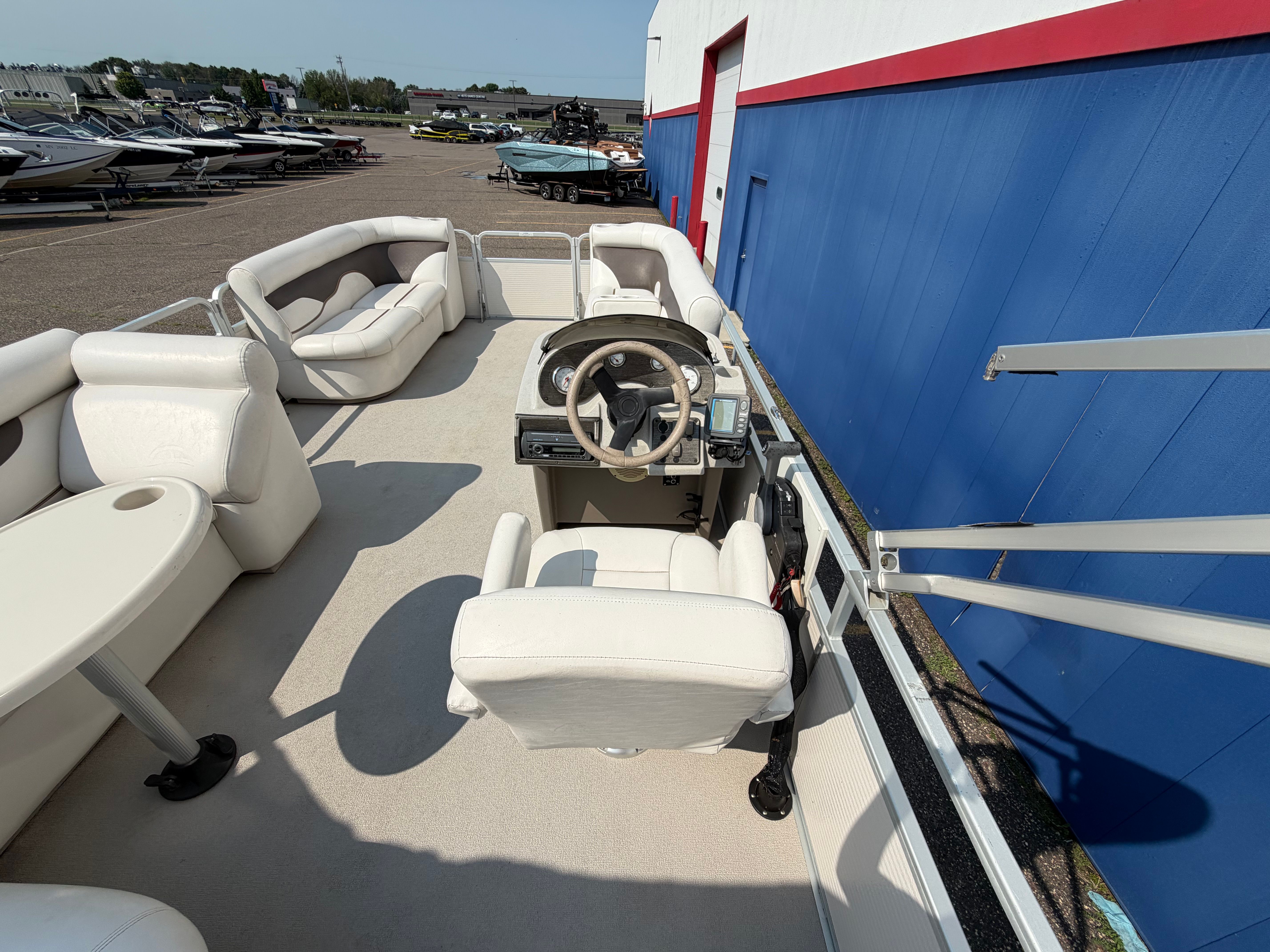 The image shows the interior of a 2007 Premier 225 Sunsation pontoon boat with white seating.