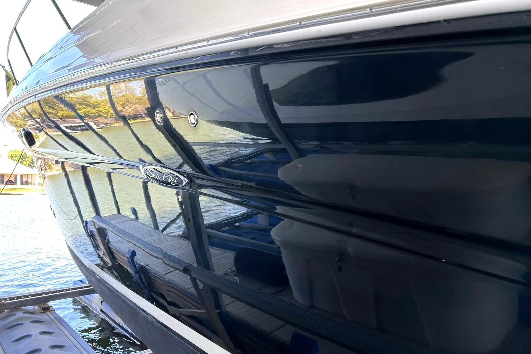 2006 Sea Ray Sundancer 320 boat reflecting water and surroundings.