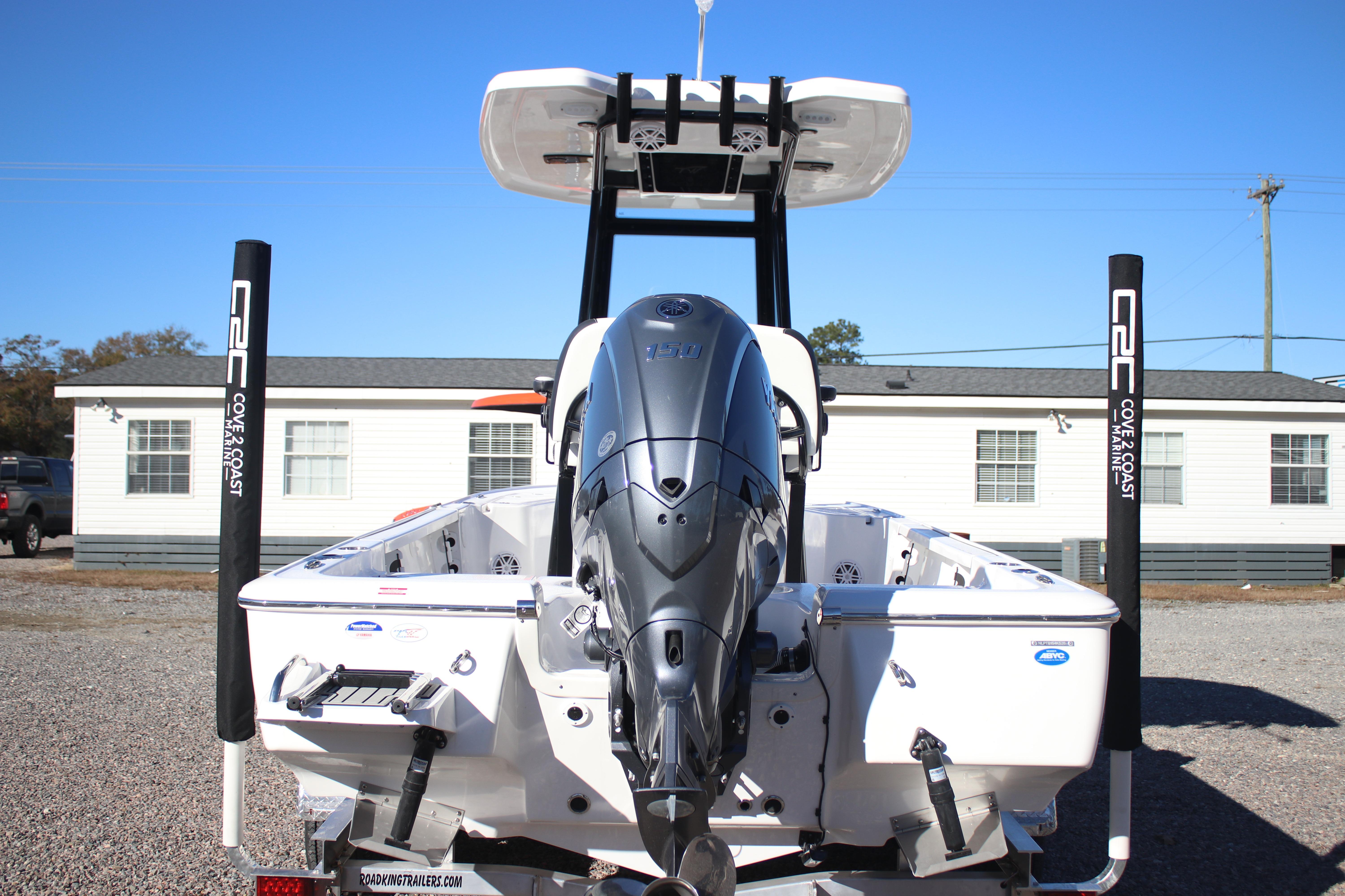 2026 Tidewater 2210 Carolina Bay boat with powerful outboard motor, parked outdoors.