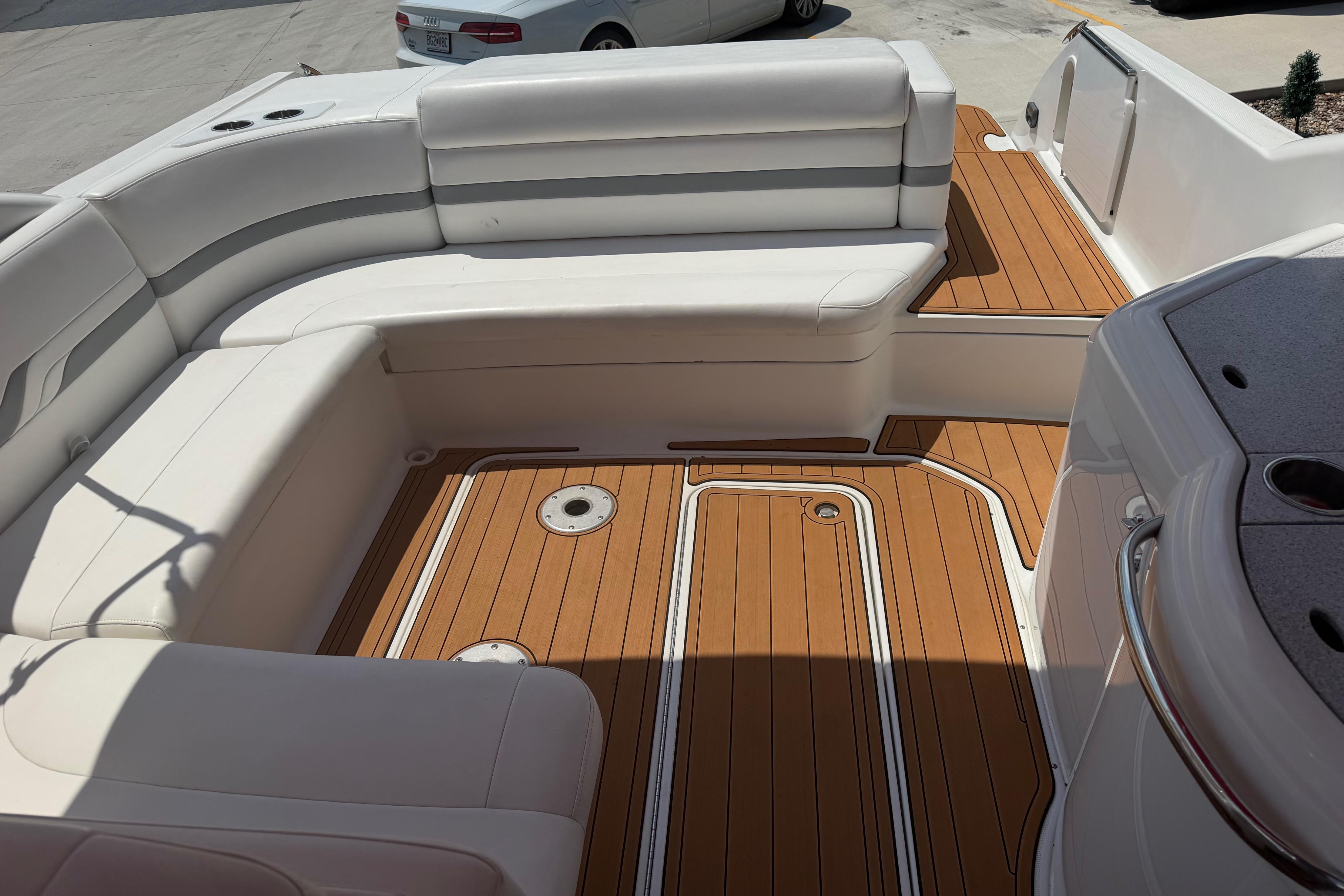 2006 Formula 330 Sun Sport boat interior with white seating and teak flooring.