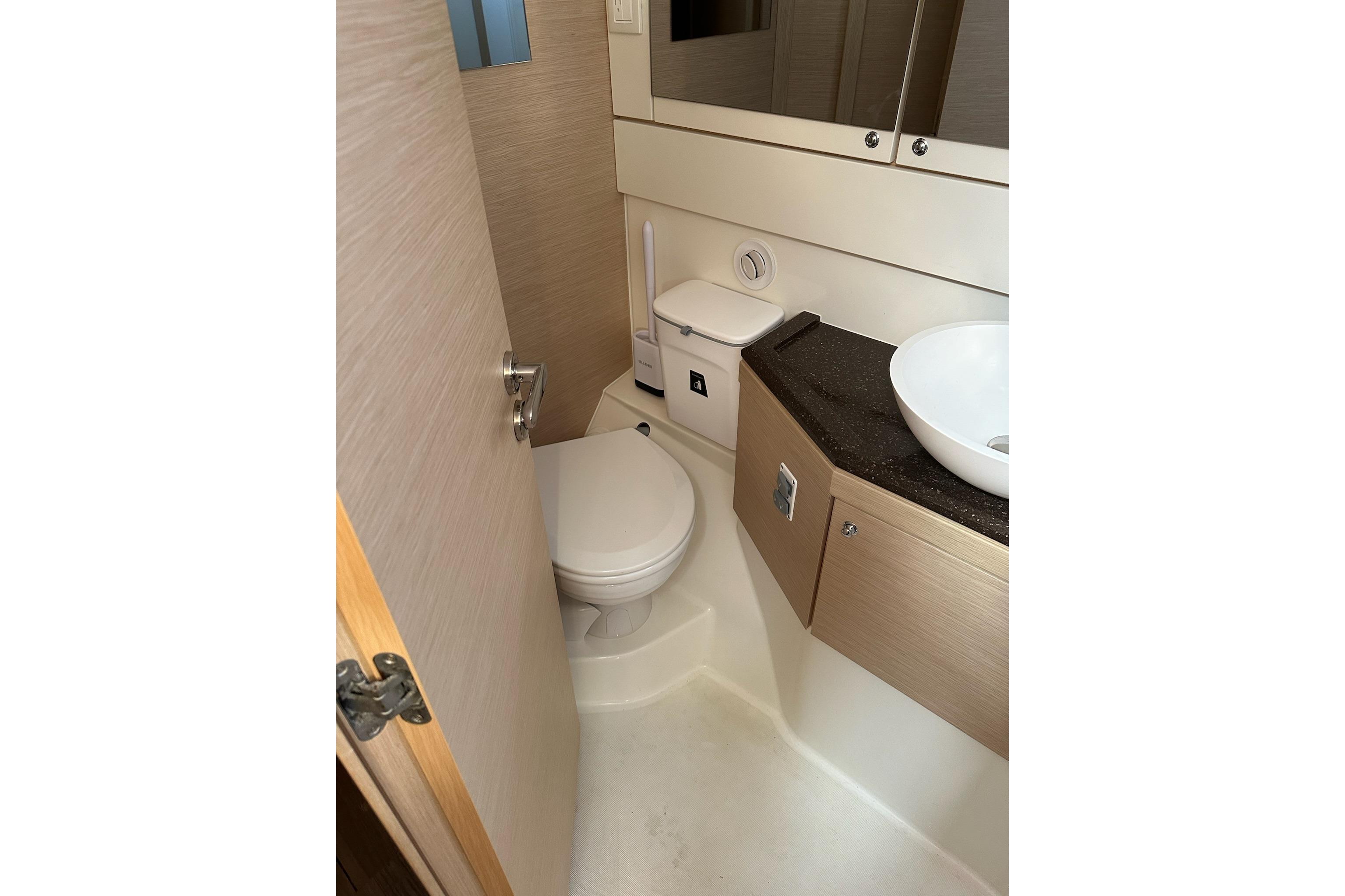 Bathroom interior of 2018 Jeanneau 51 yacht, featuring modern fixtures and compact design.