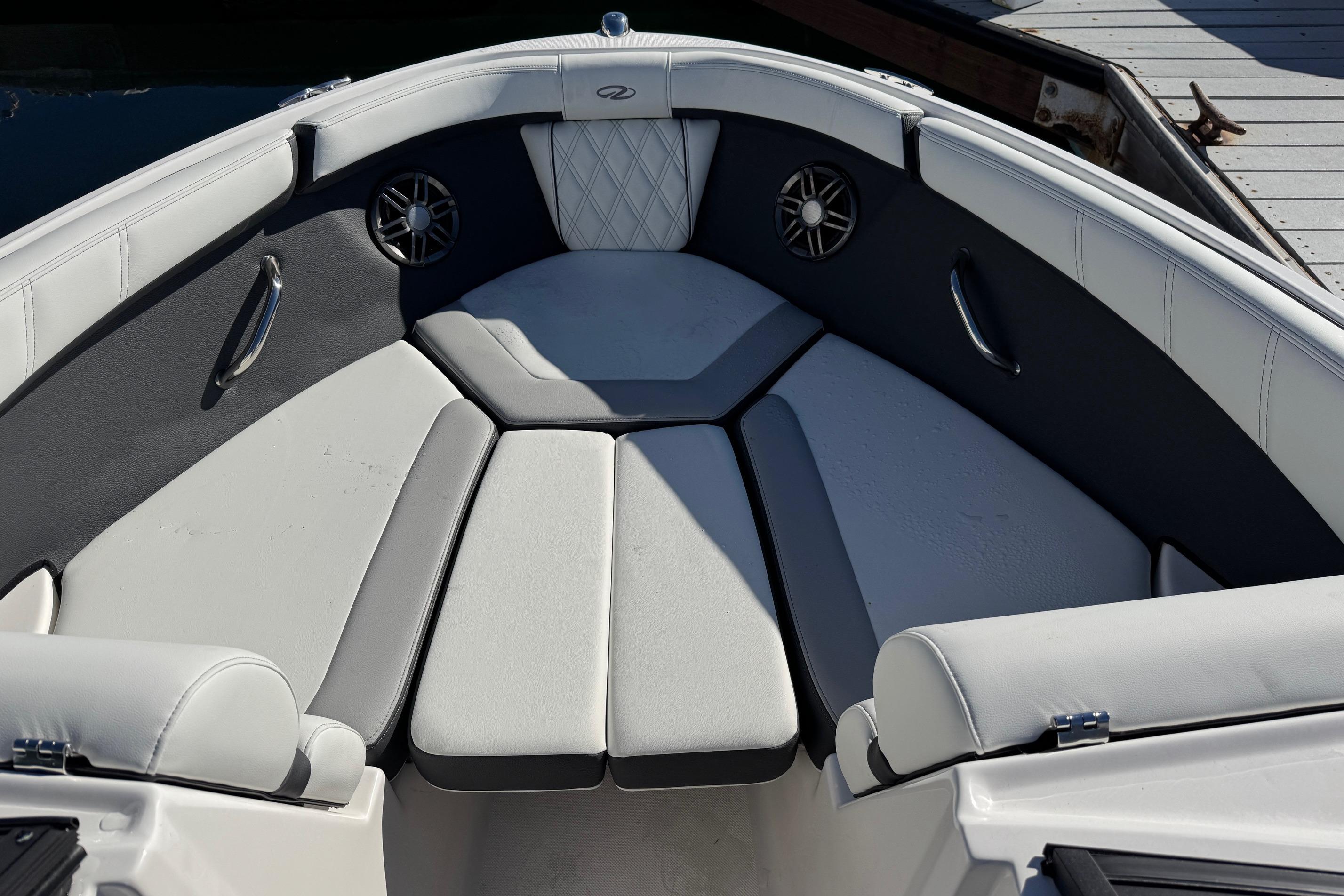 Luxurious seating area on 2026 Regal 21 OBX boat, featuring stylish upholstery and speakers.