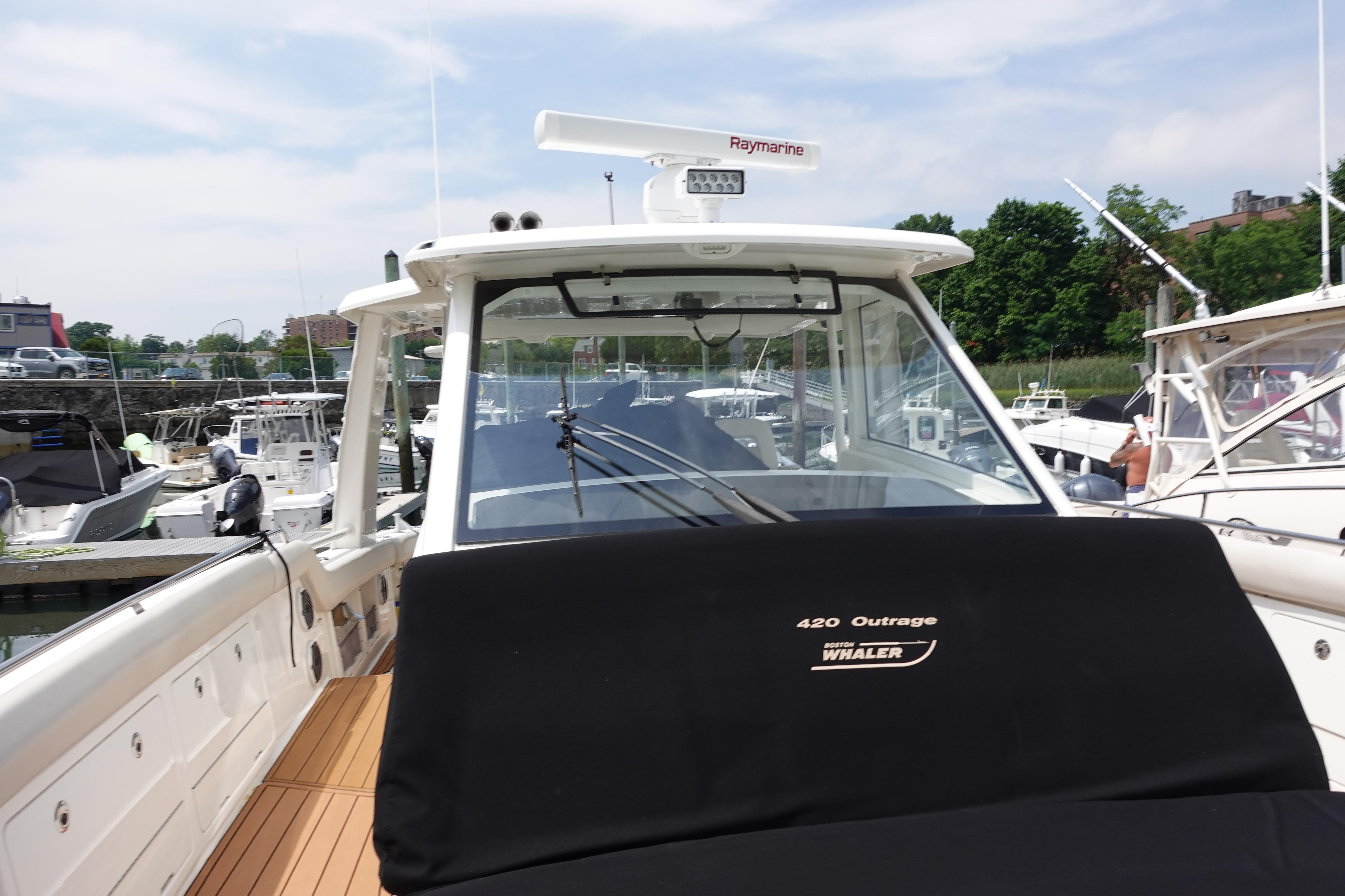Boston Whaler 420 Outrage 2020 model docked at marina, showcasing sleek design.