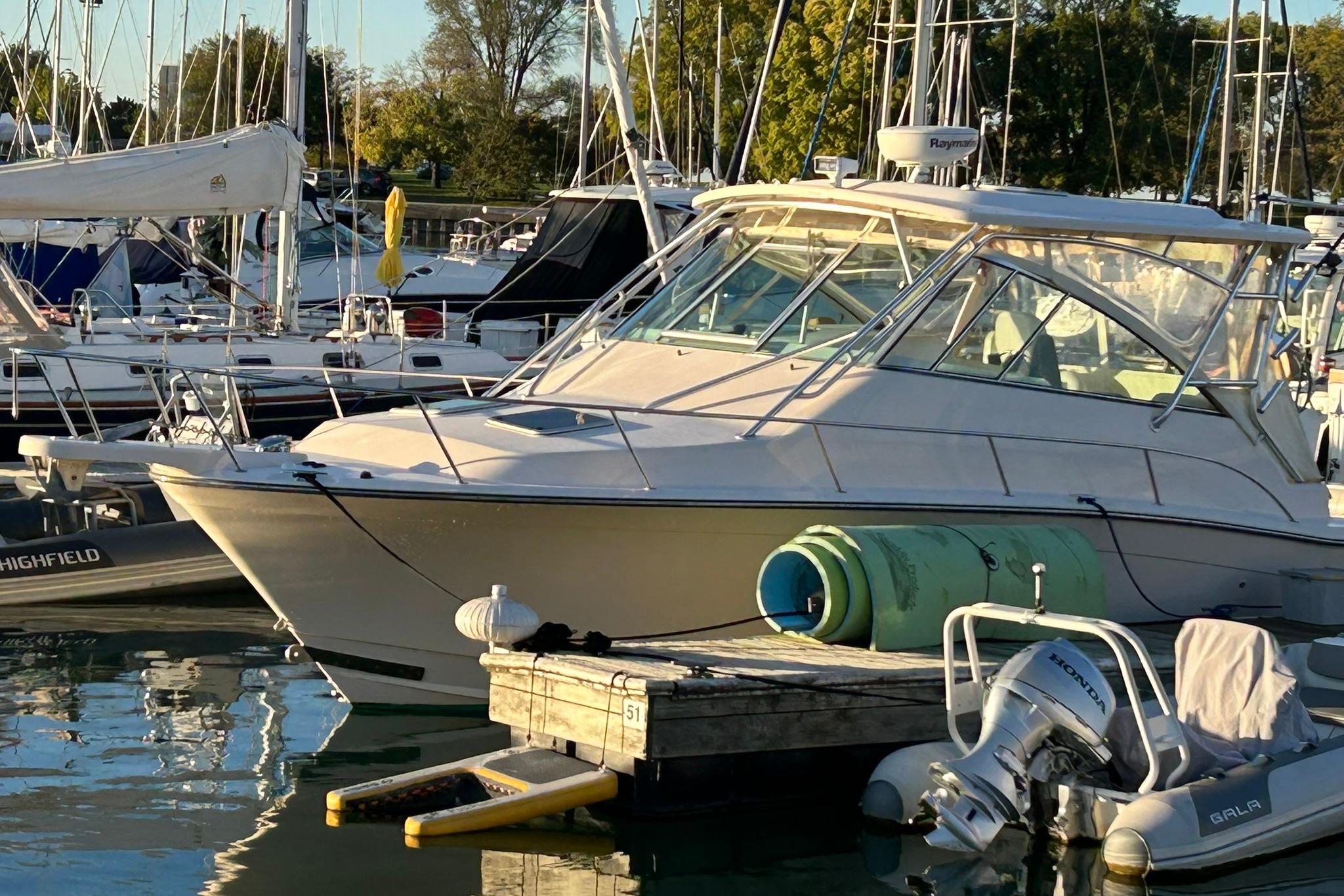 2007 Grady-White Express 360 boat docked in a marina, surrounded by other vessels.